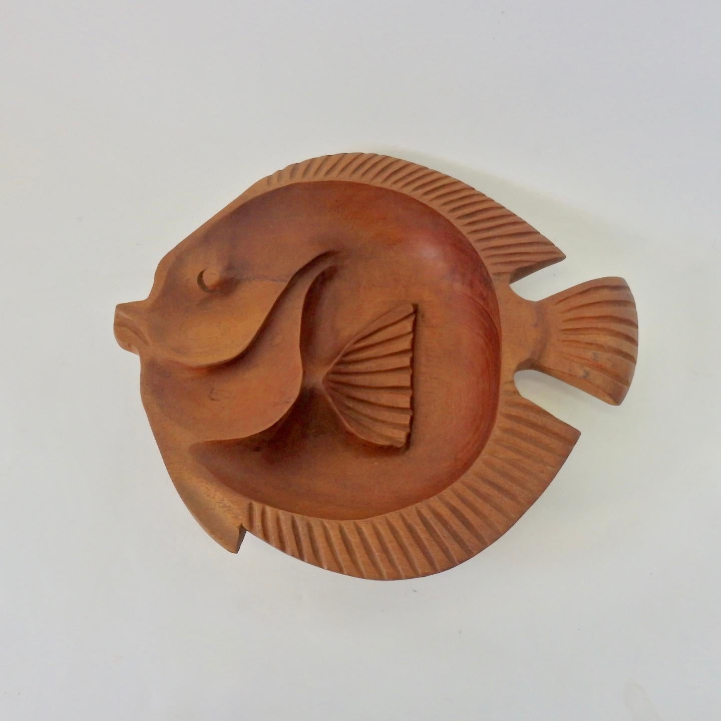 Fish form carved from solid piece of wood.