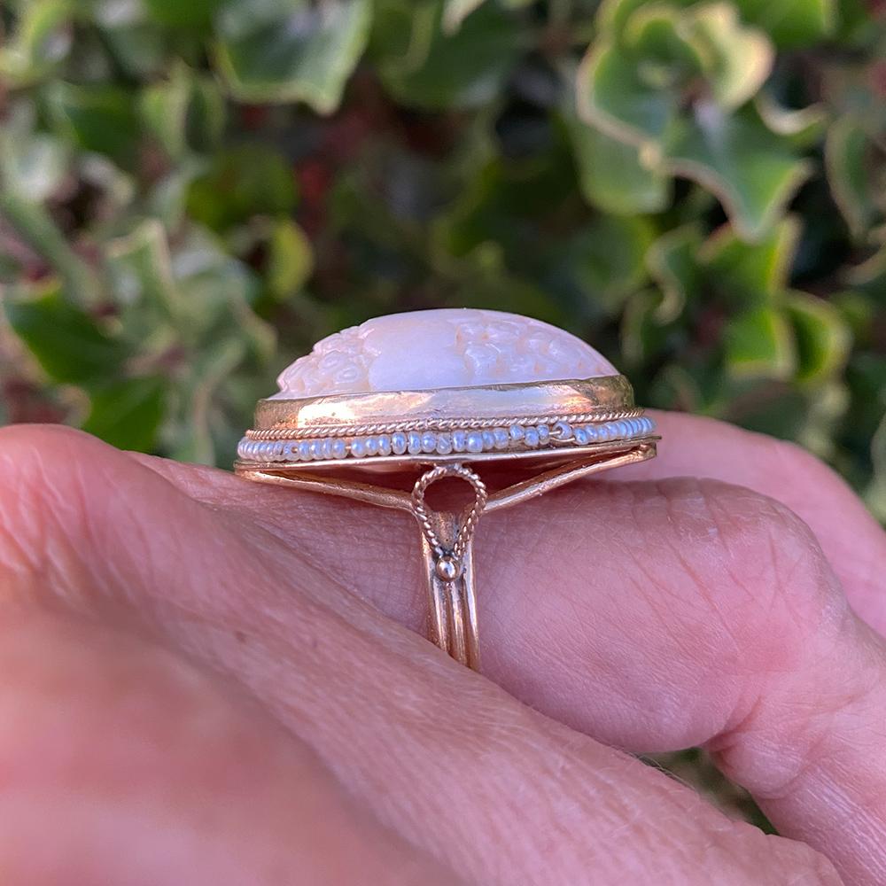 Vintage Carved Coral and Seed Pearl Victorian Ring set in 14-karat yellow gold.
Soft colors show the variation of light to darker coral color.
The image is a cloud-like, floral 
Workmanship appears to be handmade with detailed wiring at the shank's