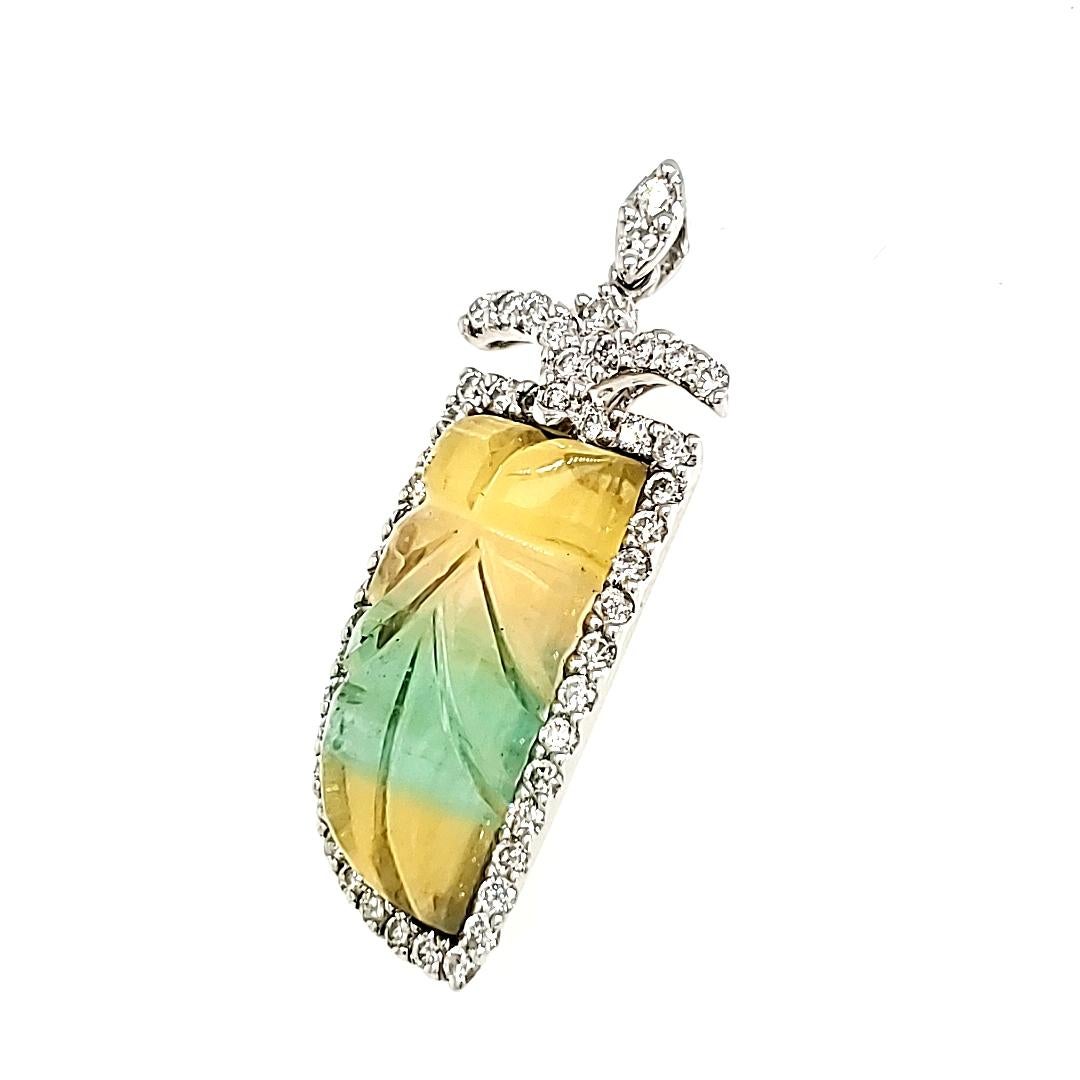 This captivating pendant features a remarkable leaf design and refined elegance that captures the beauty of nature in every detail.

At its core lies a stunning Flourite Carving, embodying the body of the leaf with a remarkable weight of 10.70