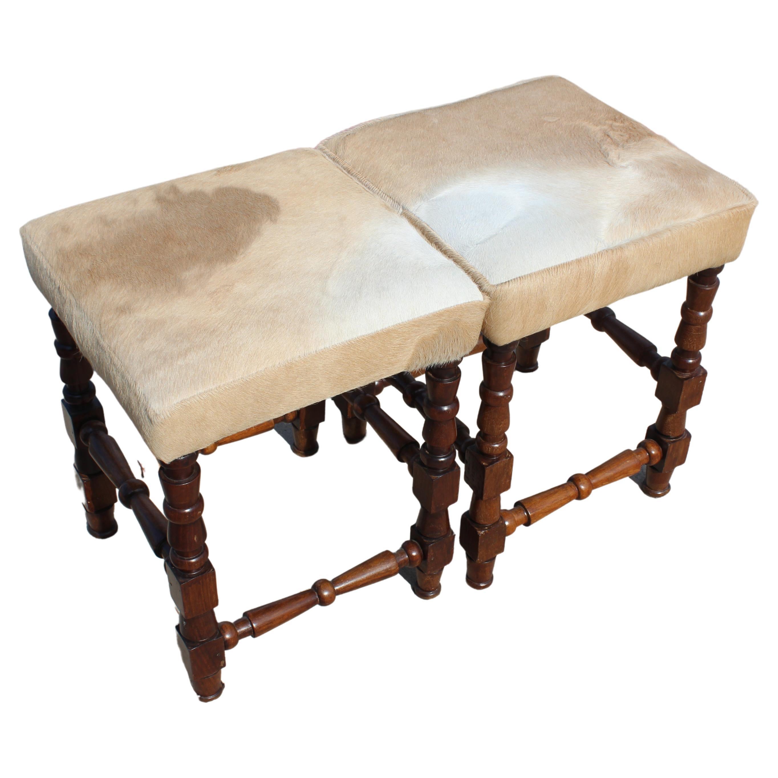 Carved French footstool, newly upholstered in a cowhide. For Sale