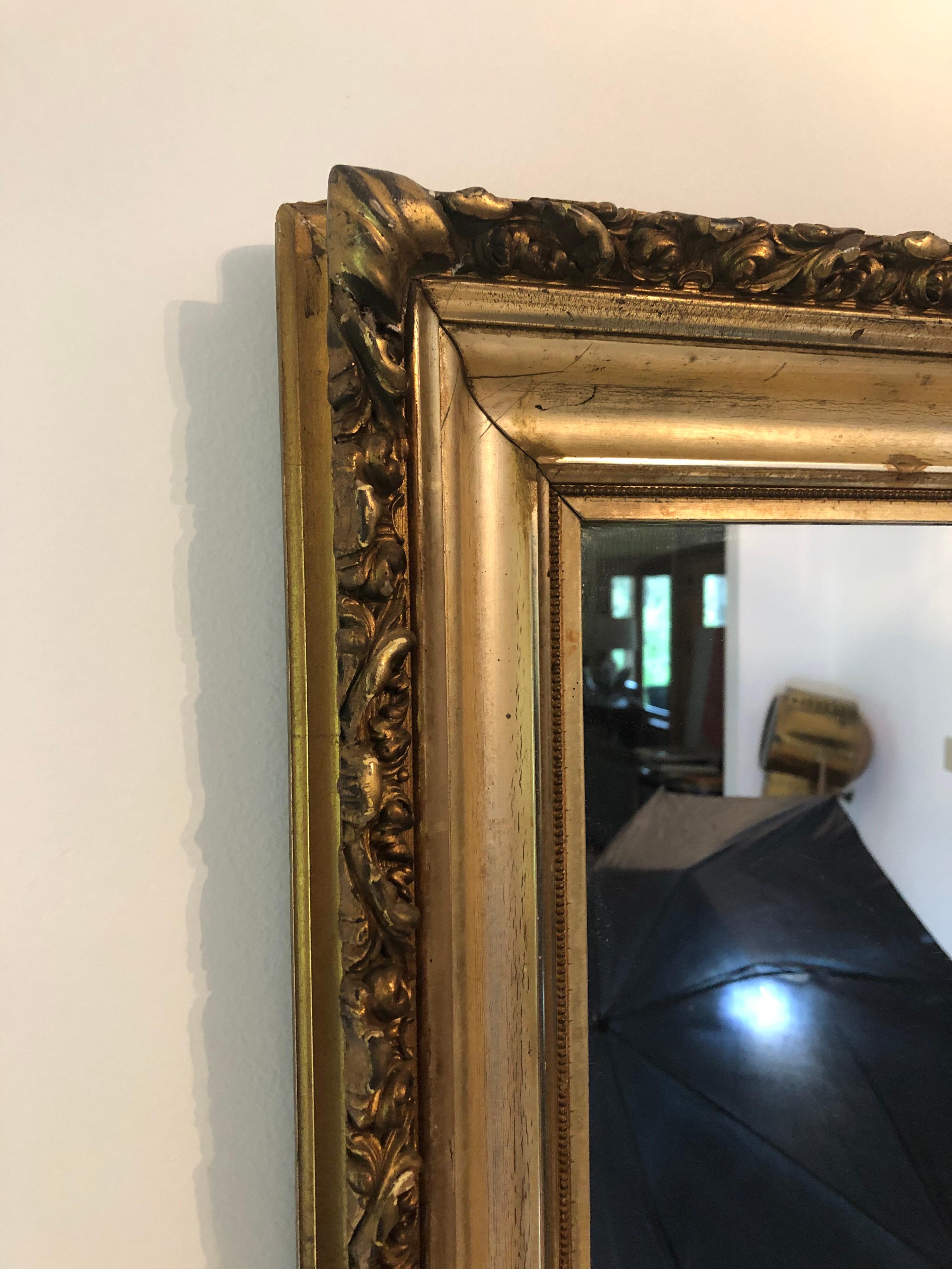 An early 20th Century French carved giltwood mirror.