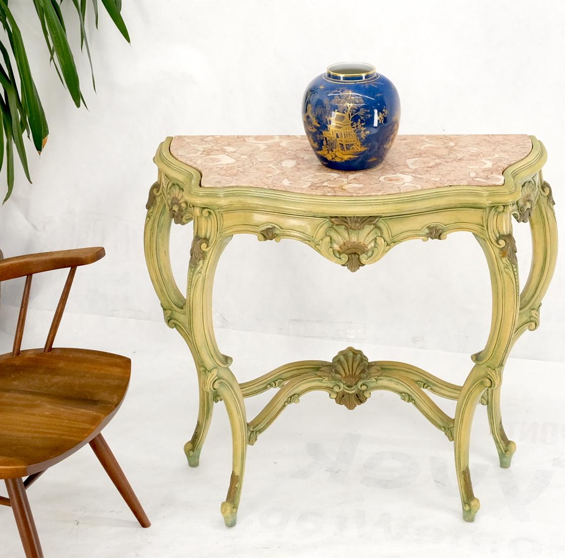 Carved French Regency paint decorated console table w/ rouge pink marble top.
Hand painted carved wood frame green, olive, yellow. Figural pink marble top. Nice compact to medium size.