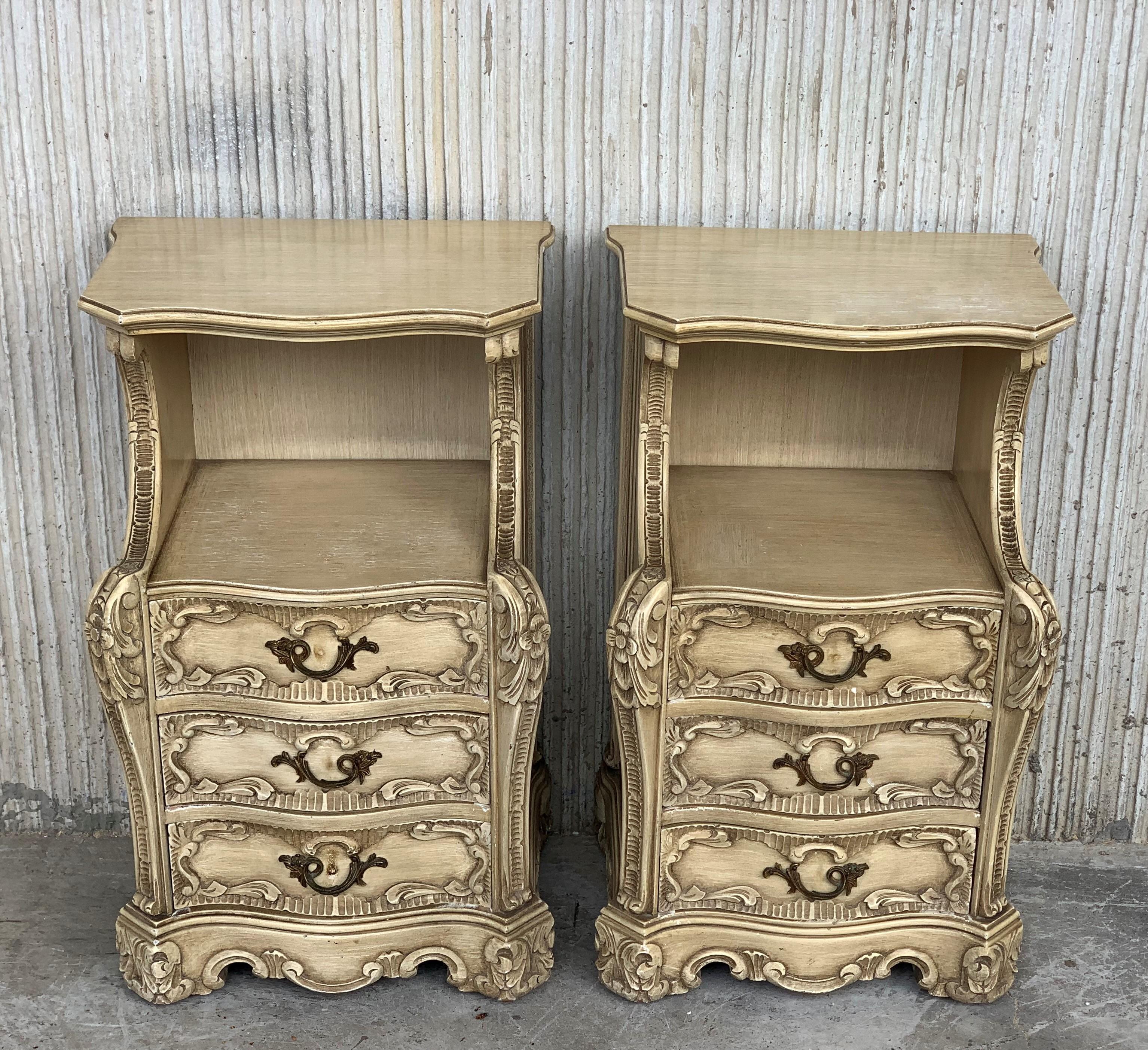 Carved French Rococo style pair of nightstands with open shelve and three drawers, circa 1930s.

The tables stands on four ornately carved cabriole shaped legs and depicts a basket of roses on a beautiful carved wood scrolled base.