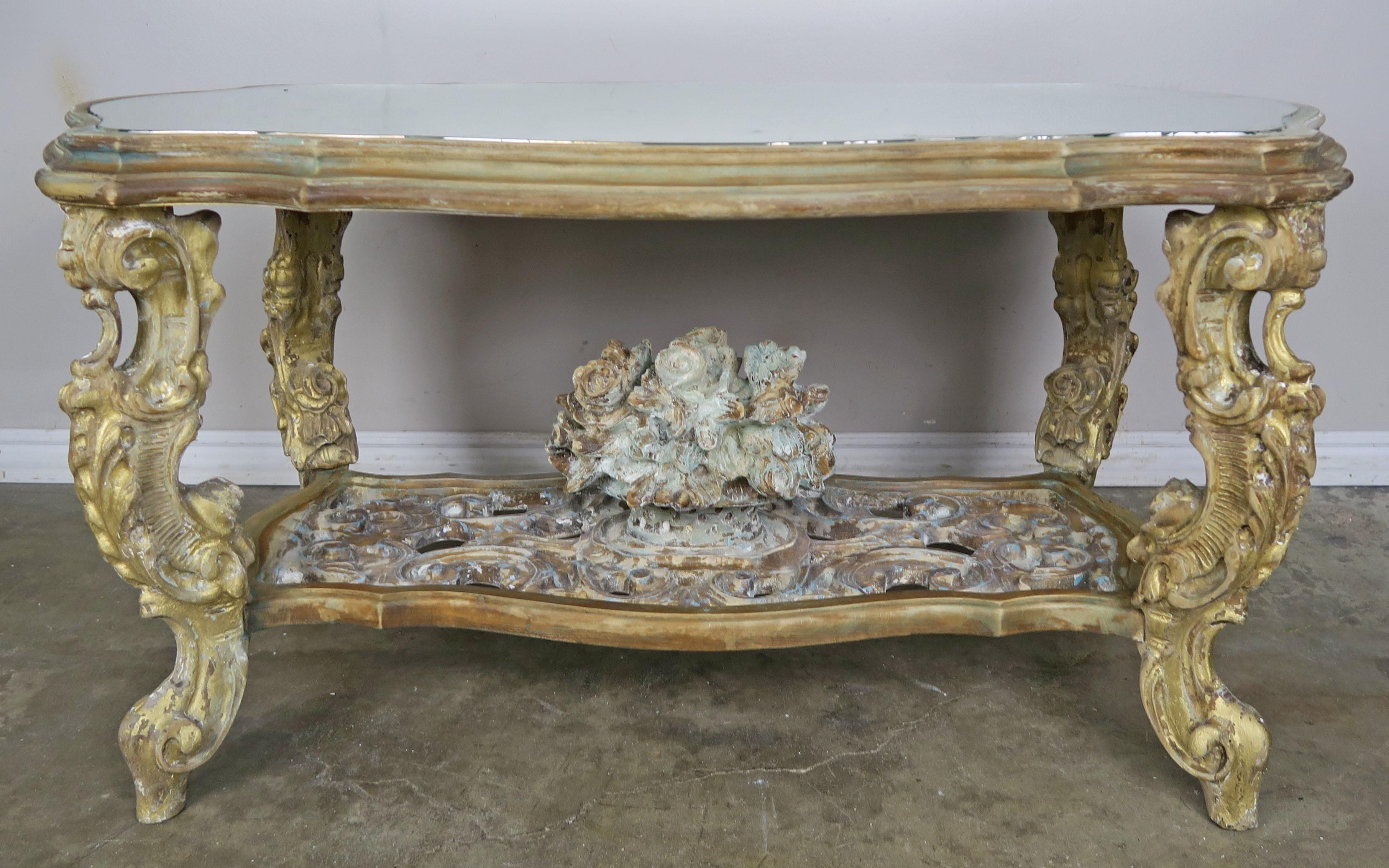 Carved French painted Rococo style tea table with silvered mirror top. The table stands on four ornately carved cabriole shaped legs and depicts a basket of roses on a beautiful carved wood scrolled base. Unique shaped silver leaf mirrored top.