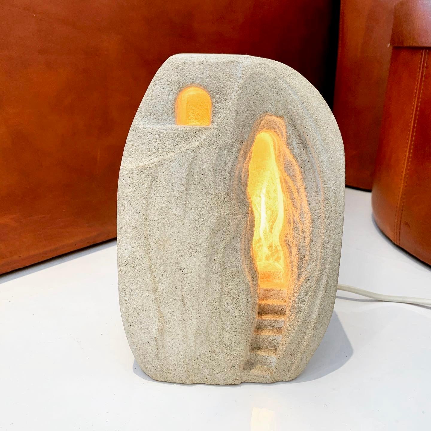 Stunning carved stone lamp made in France, circa 1970s. Depicts a cave with stairs. Looks great on and off. Hand switch on the cord. Great piece of usable art. Some initials/carving on backside. Excellent condition.