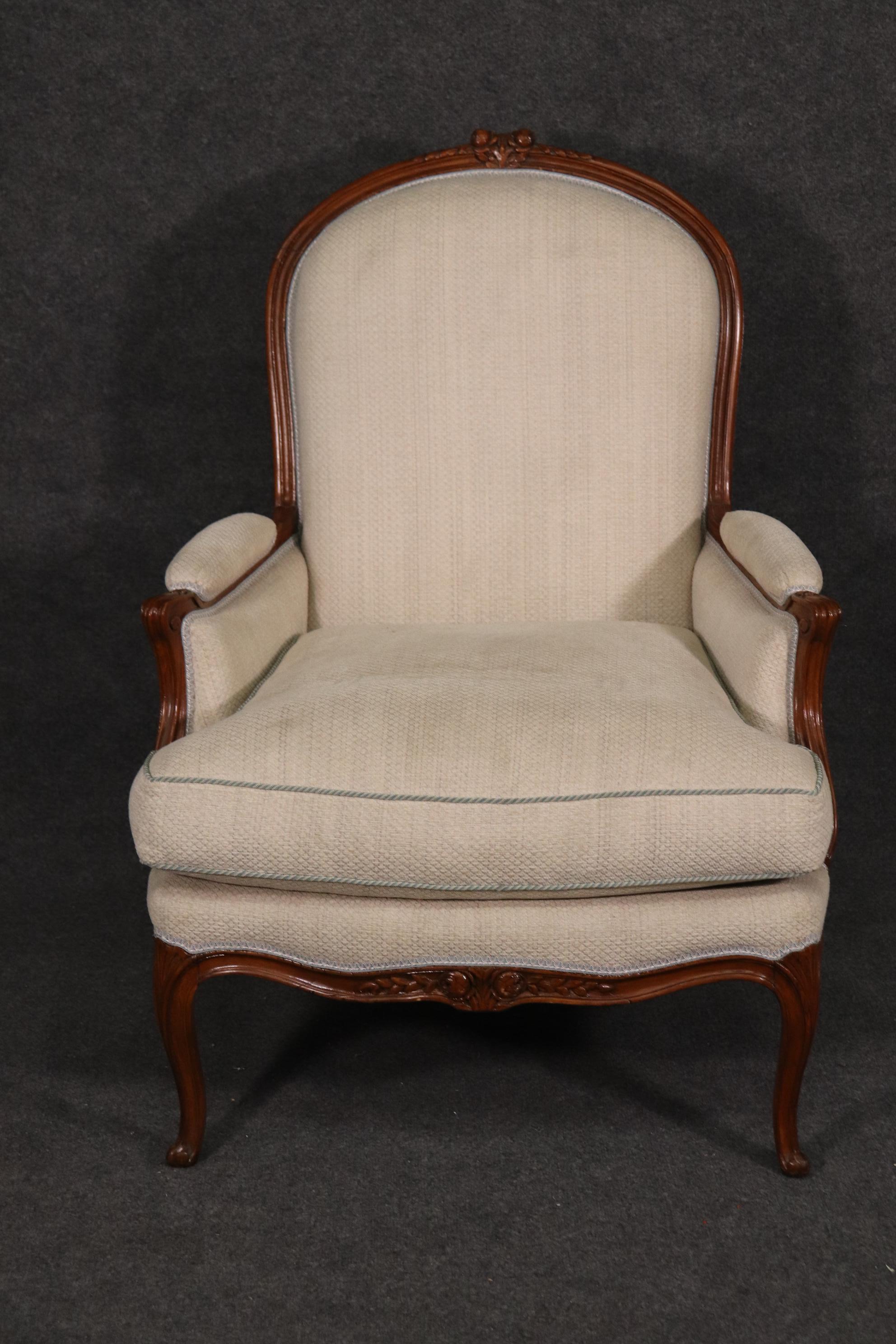 This is a superb carved French bergere chair. The chair is in good condition and will show signs of wear and use. The upholstery is used so it's unreasonable to expect perfection but the fabric is still usable. The chairs measure 42 inches tall x 32