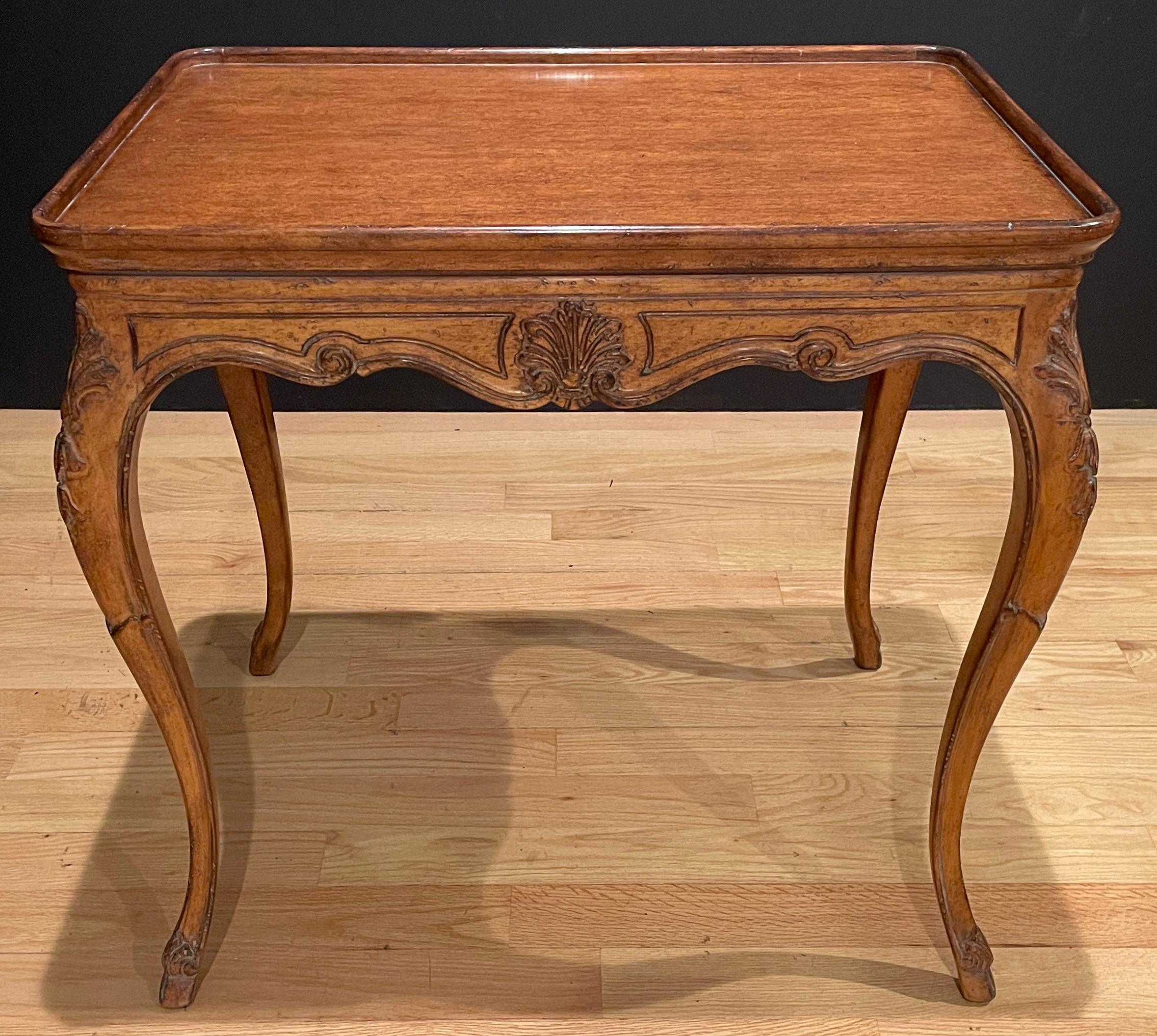 Provincial French carved fruitwood Louis XV style side table. Country French styling with raised tray form top panels and carved elements on apron and cabriole legs.