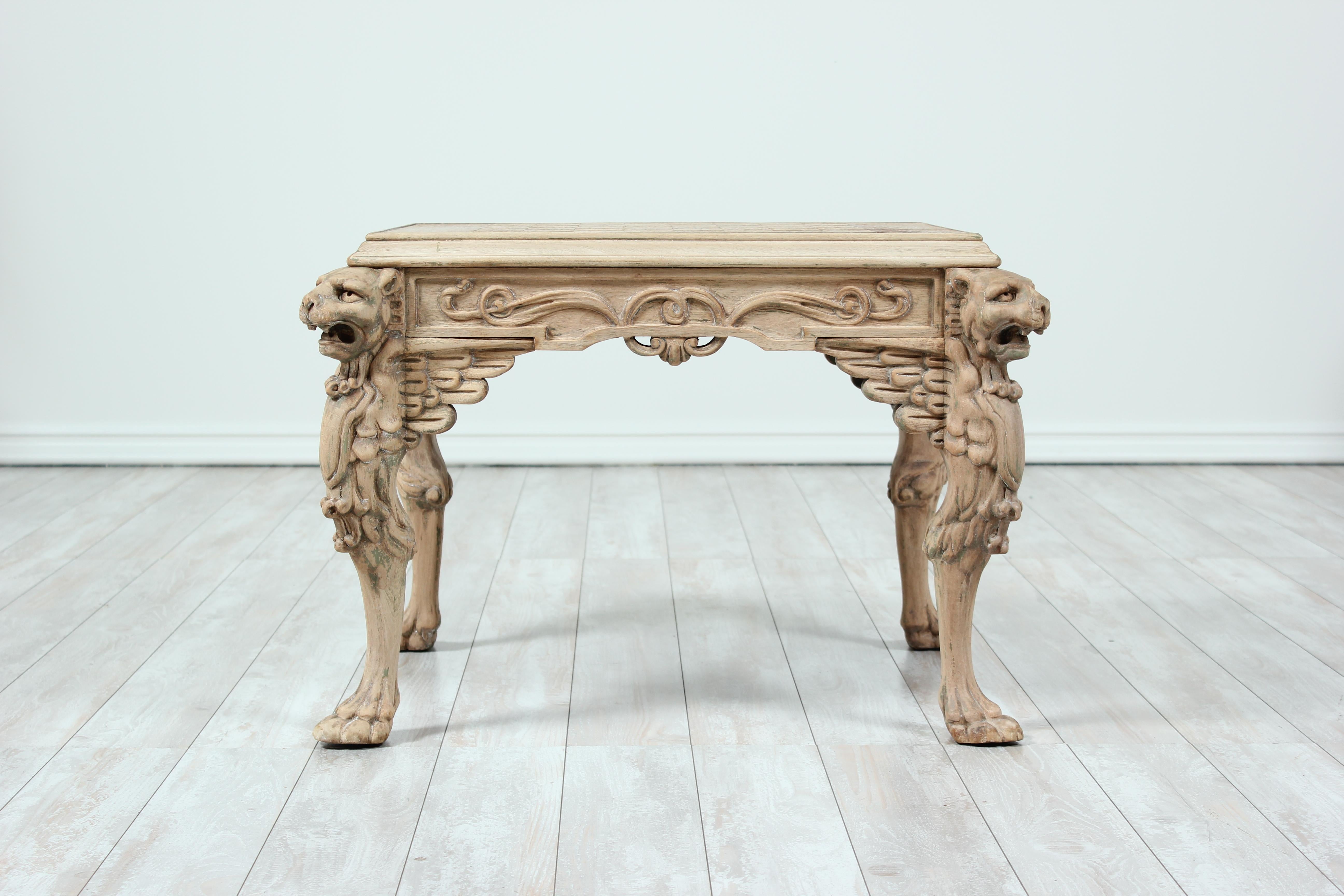 Handsome Italian, 1940s painted and carved wood game table in the Renaissance Revival style. The table features nicely carved lion heads and paw feet with a game top made of cork. The proportions of this table facilitate it to be used as a coffee or