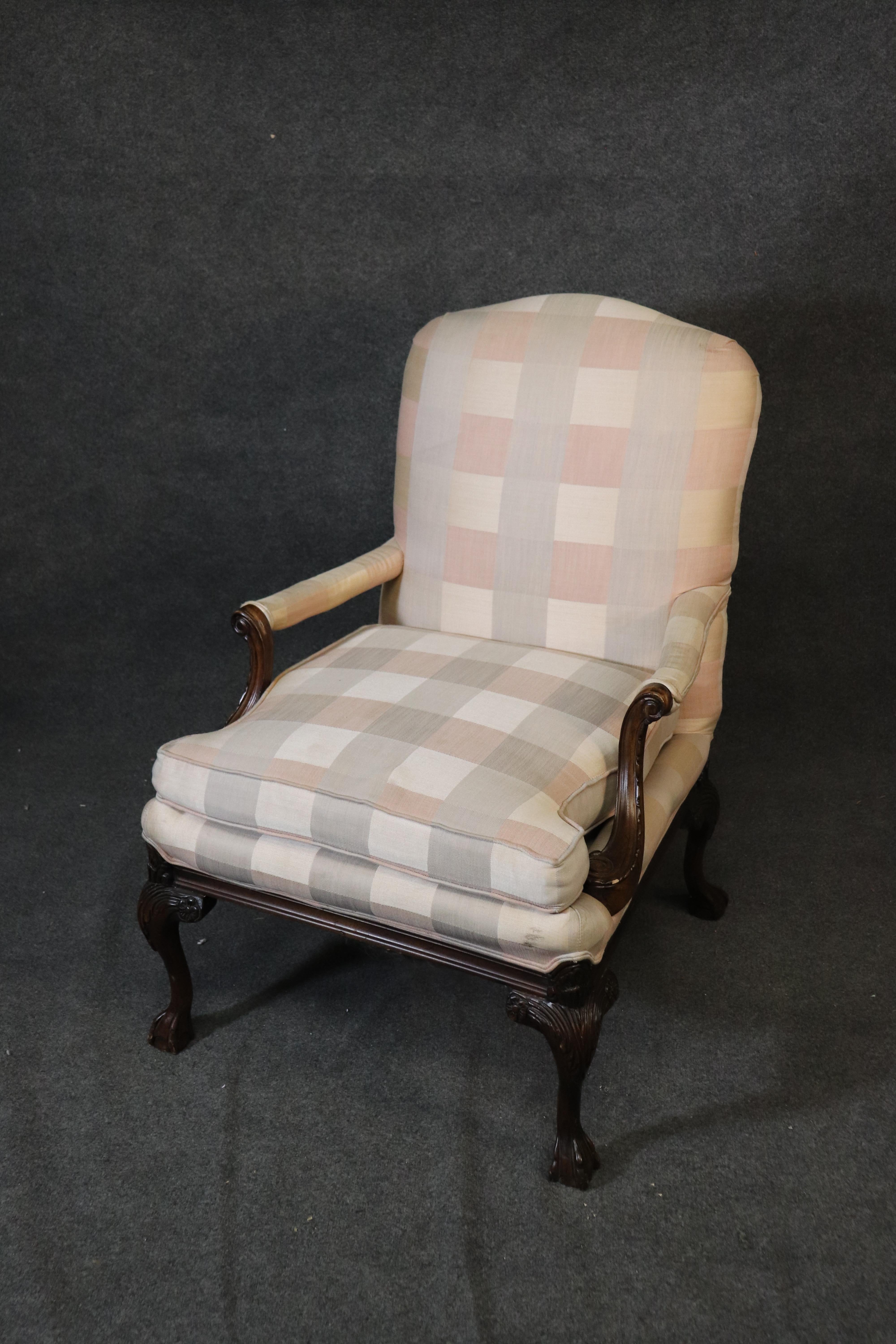 This is a fine quality mahogany carved Georgian style bergere chair and ottoman. The chair and ottoman are in good vintage condition and have subtle signs of use as to be expected. They measure 41 tall x 28 wide x 31 deep and a 21 inch seat height