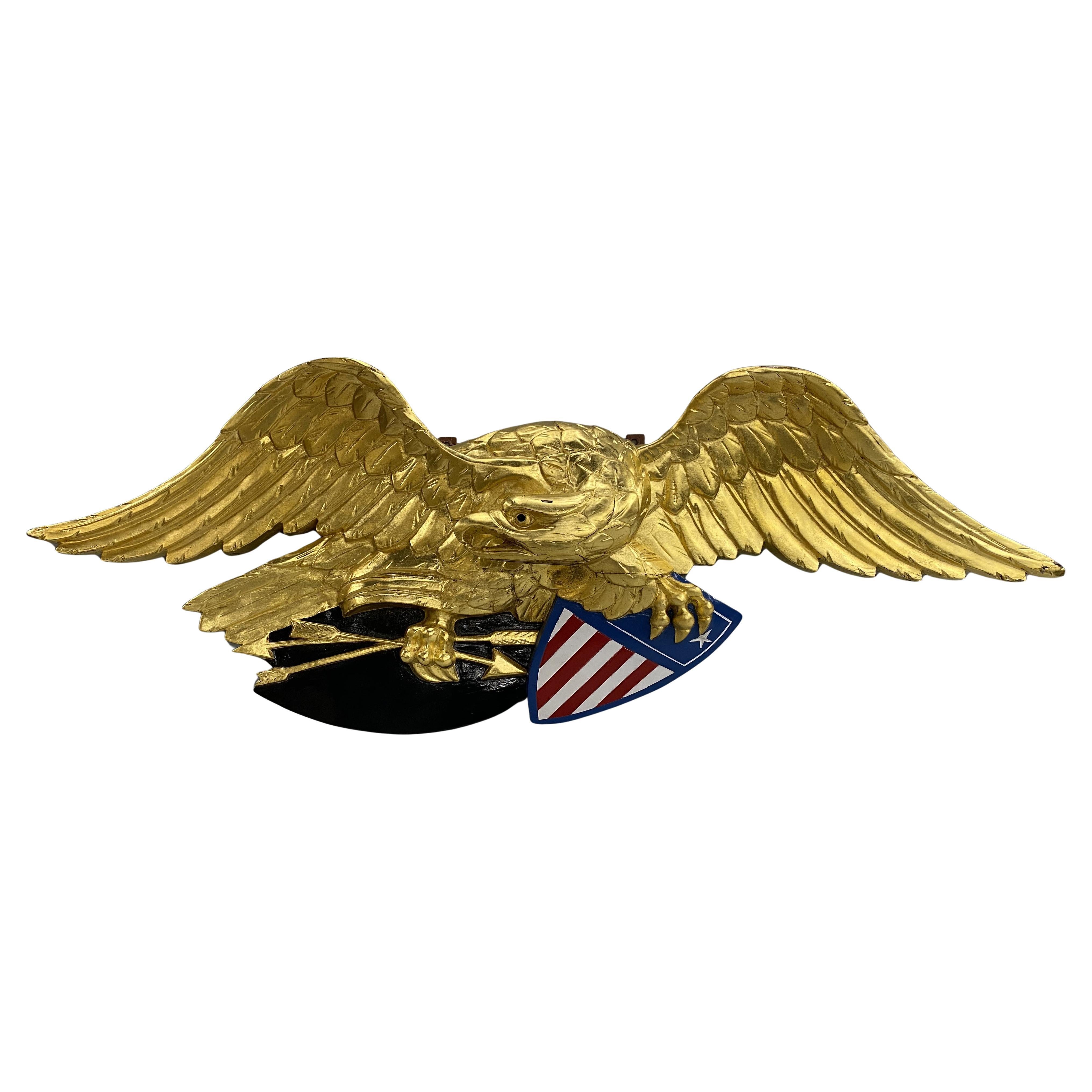 Plaque d
aigle américain en bois sculpté et doré avec bouclier de la liberté polychrome