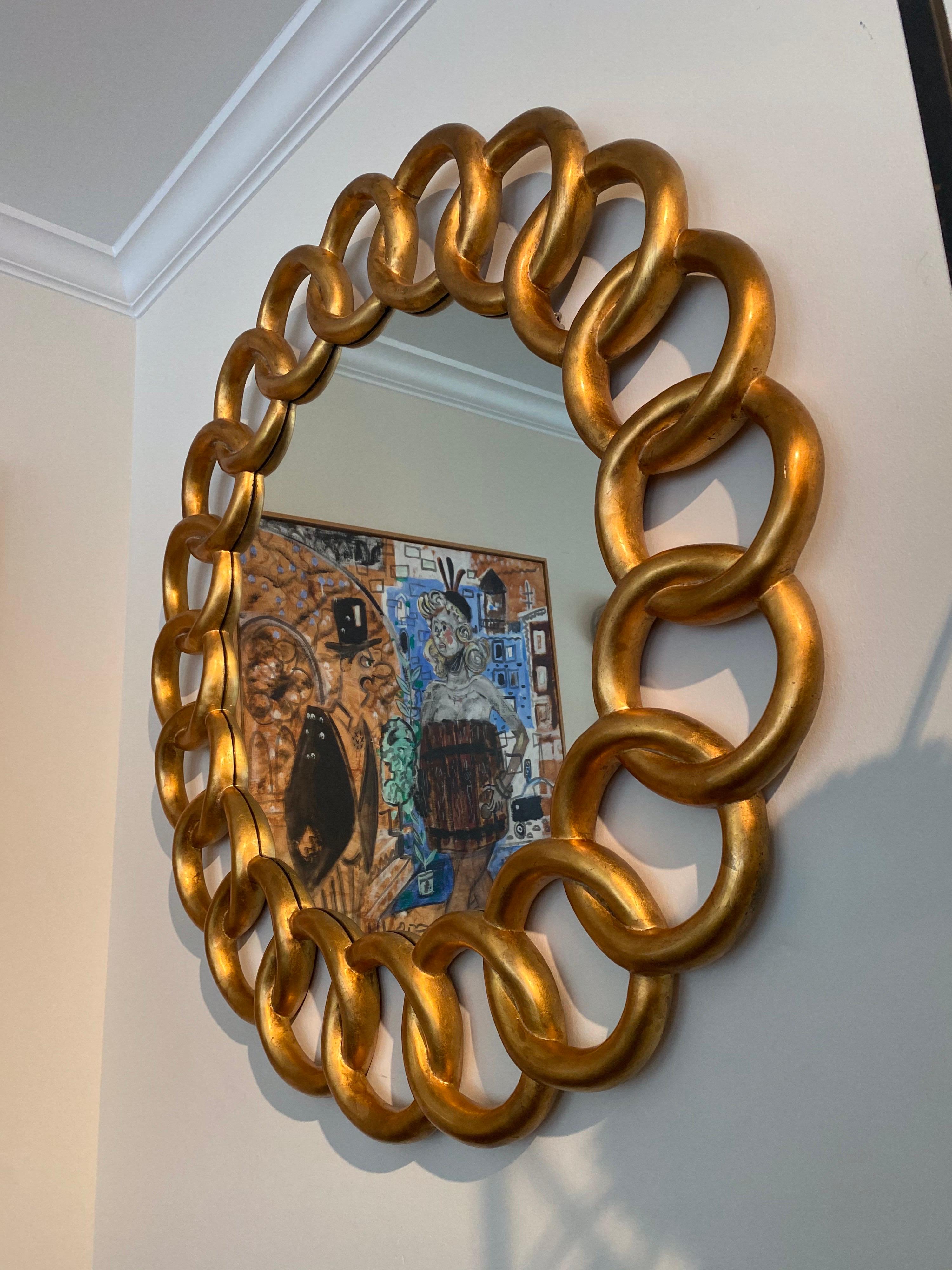 Heavy carved and gilded Pretzel design round mirror by Harrison & Gil.
