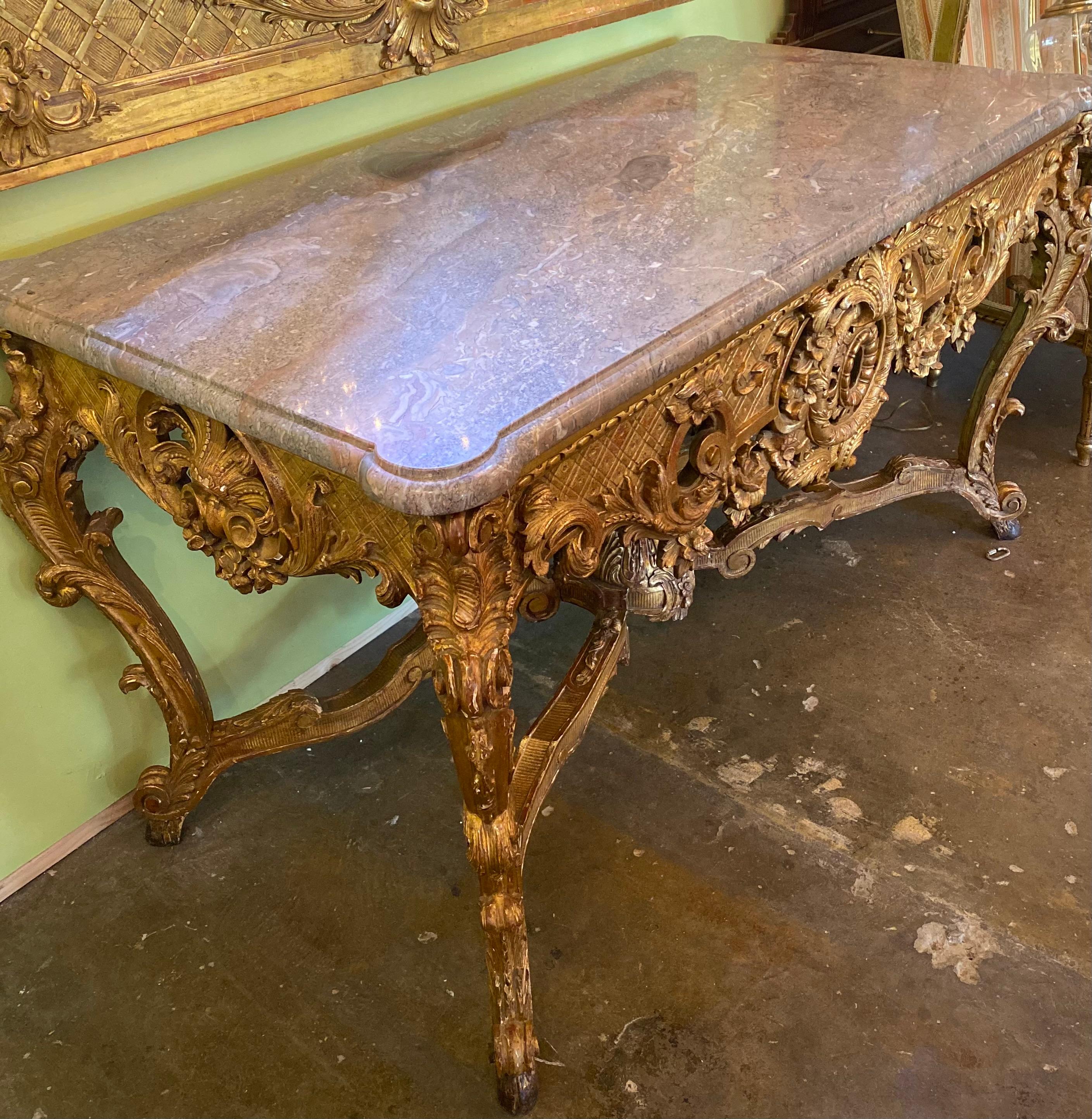 Carved and gilt console table with X shape stretchers, and gray marble top 19th century.

  