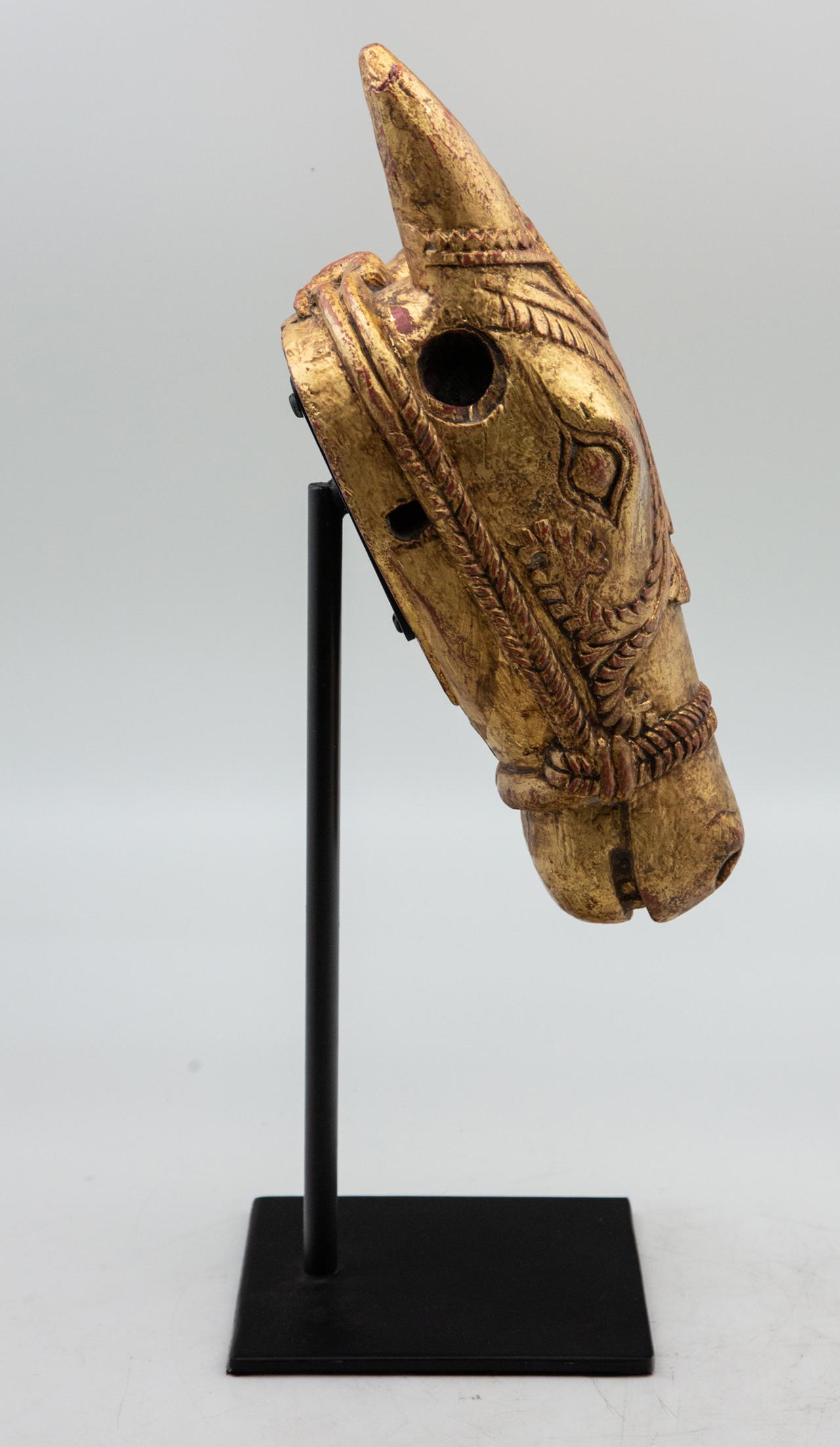 Carved gilt horse head on stand. Carved from wood, mounted on custom black metal stand. Measures: 6