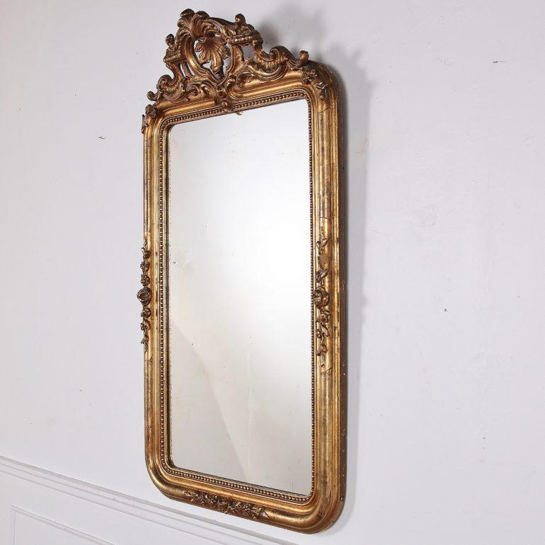 19th century French Louis Philippe gilt mirror with floral detailing.

   