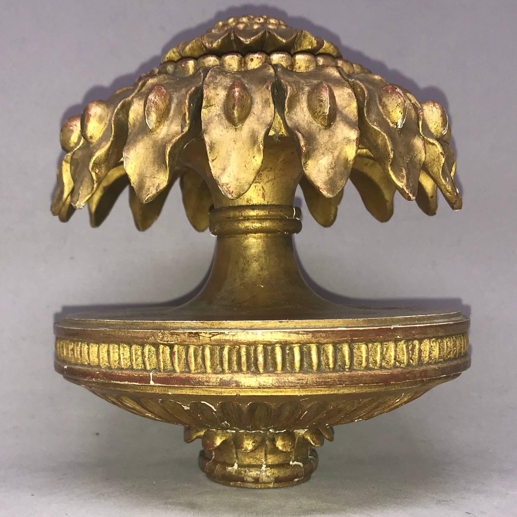 Carved gilt-wood sunflower finial ornament. Gilt carved and gesso sunflower decoration issuing from round neoclassical base. Europe, early 20th century.
Dimensions: 5.25