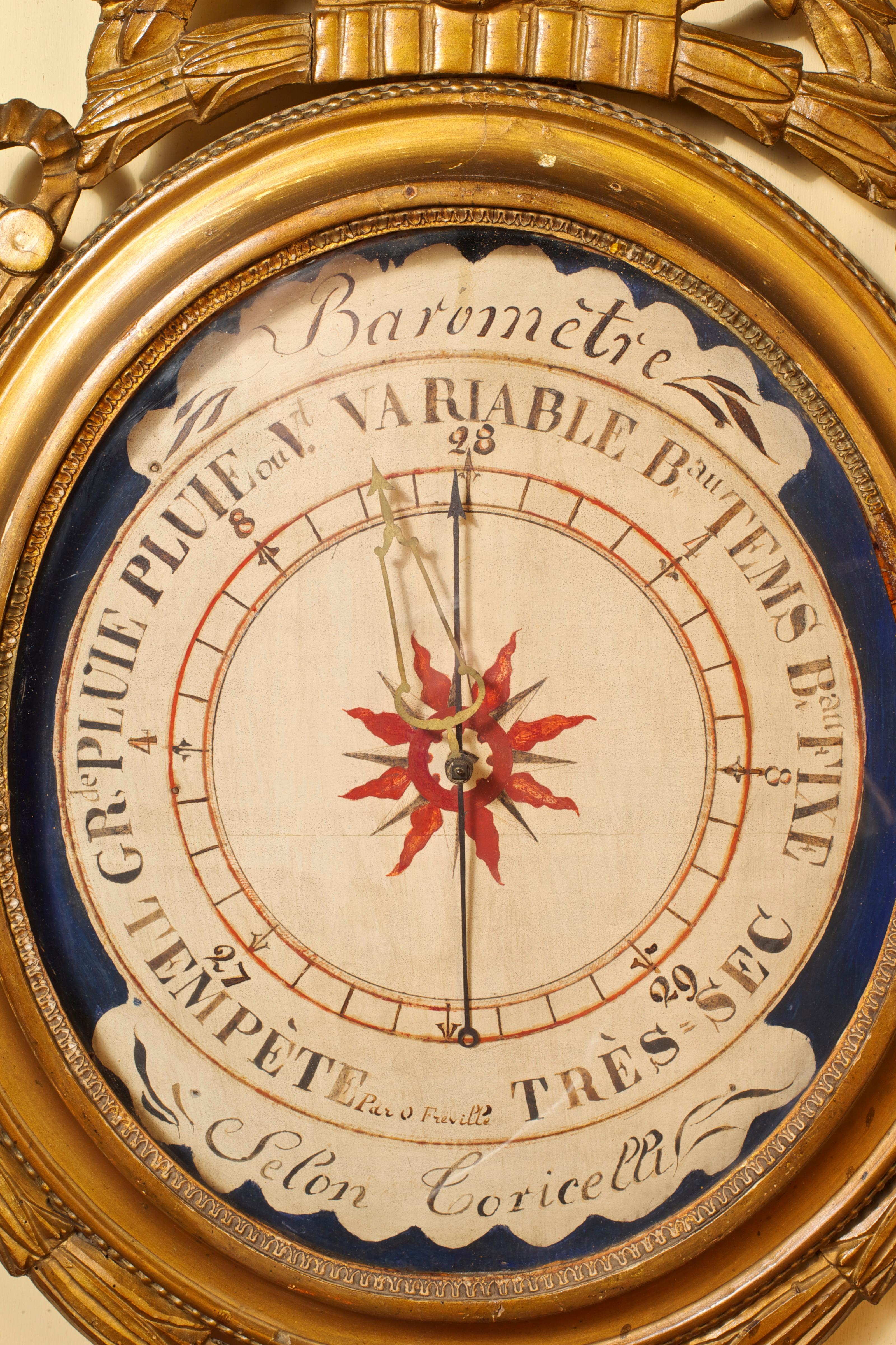 Carved giltwood Louis XVI French barometer, painted wood dial with blue ground and starburst centre. Original pointer and centrally mounted setting hand. 

 The dial signed 'Par Freville, Barometre, Secon Toricelli'. After Toricelli (1608-1647),