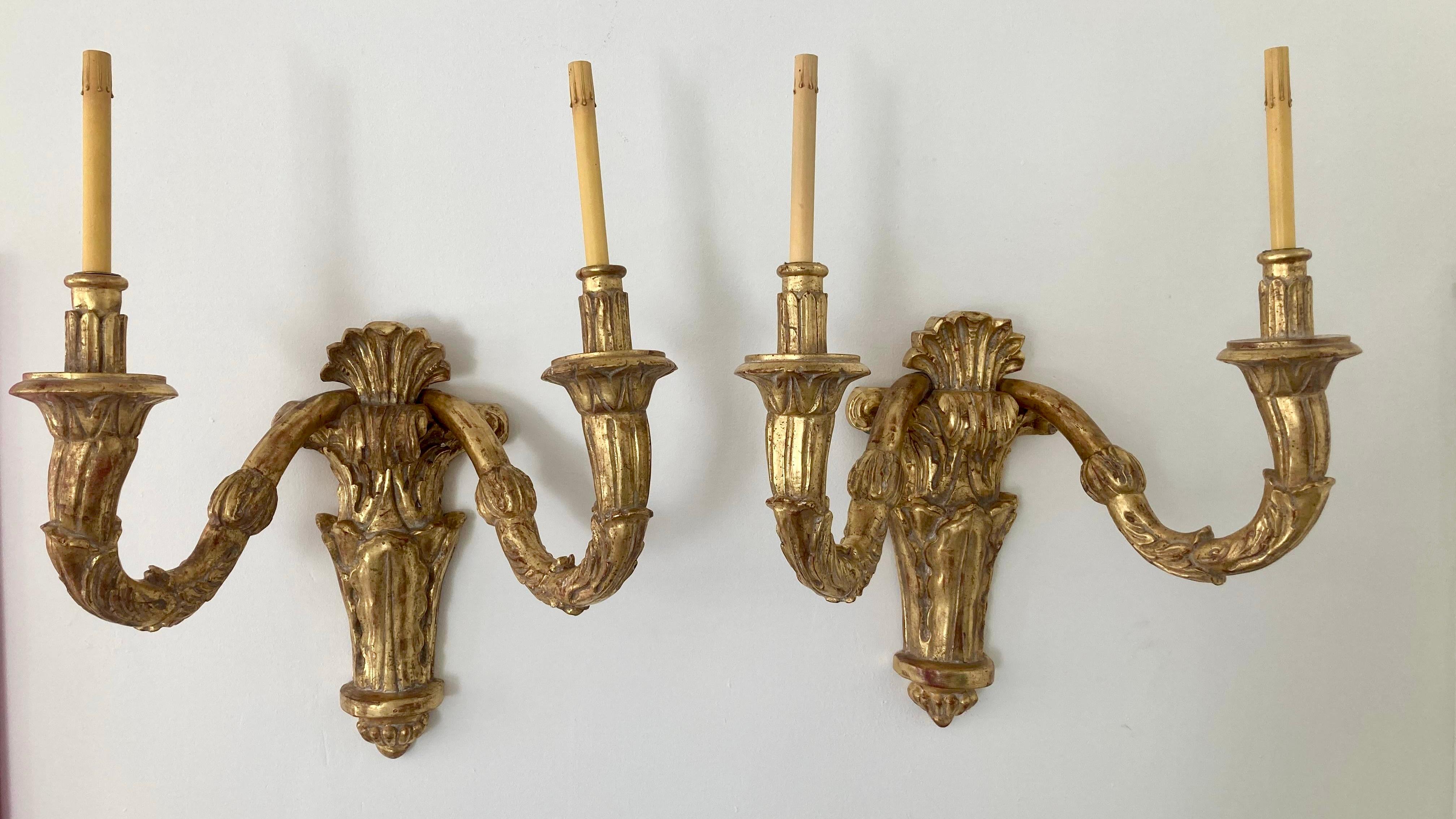 Very large scale pair of carved gilt wood wall sconces in a French Louis XVI Style. Very dramatic oversized scale will certainly add some French Style to your home. We actually have 2 pairs available in inventory.