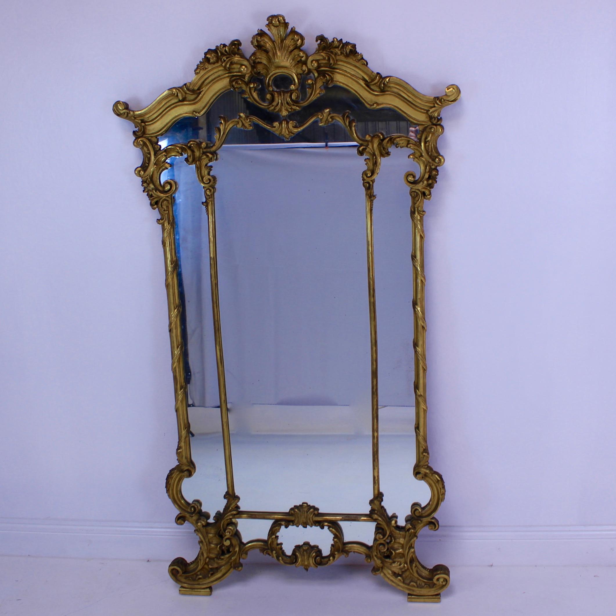 A good example of this carved wood gilt mirror, the design on the base makes it stand really well on a commode. This is a carved wood mirror, it’s not made from gesso.