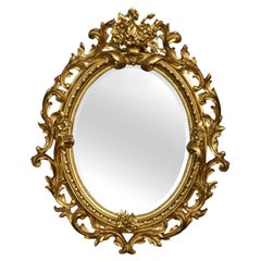 Carved gilt-wood oval wall mirror
