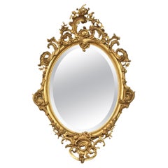 Carved gilt-wood oval wall mirror