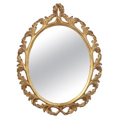 Carved gilt-wood oval wall mirror