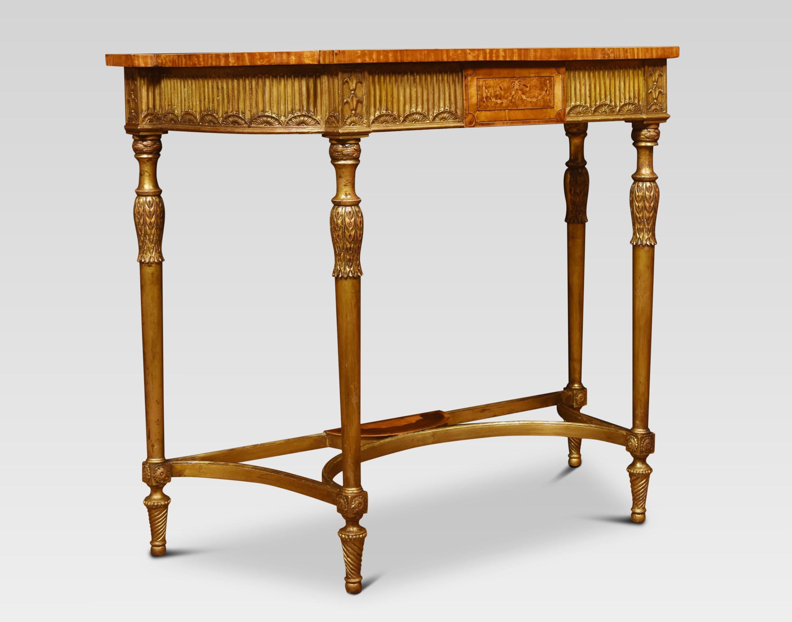 A carved gilt-wood and painted console table, the cross-banded satinwood top hand painted with cherub and floral garlands, above a gilt-wood panelled apron with central inlaid detail, raised upon carved and tapered supports united by stretchers,