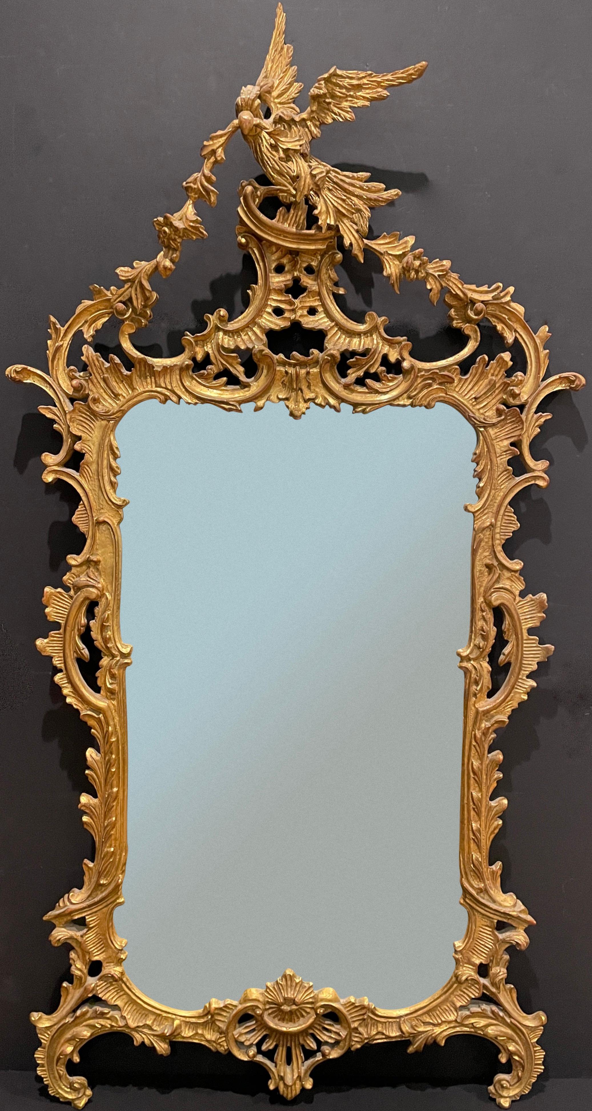 Gilt and carved wood Chinese Chippendale beveled mirror. Chinoiserie style giltwood frame with central Ho Ho bird at top.