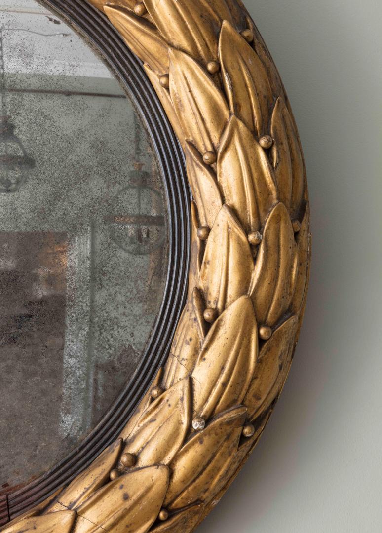 A Carved Giltwood Convex Mirror (II) with leaf carved details and original mercury plate.

Additional information:
Dimension: Diameter: 72 cm, 28 3/8″
Depth: 7.5 cm, 3″
