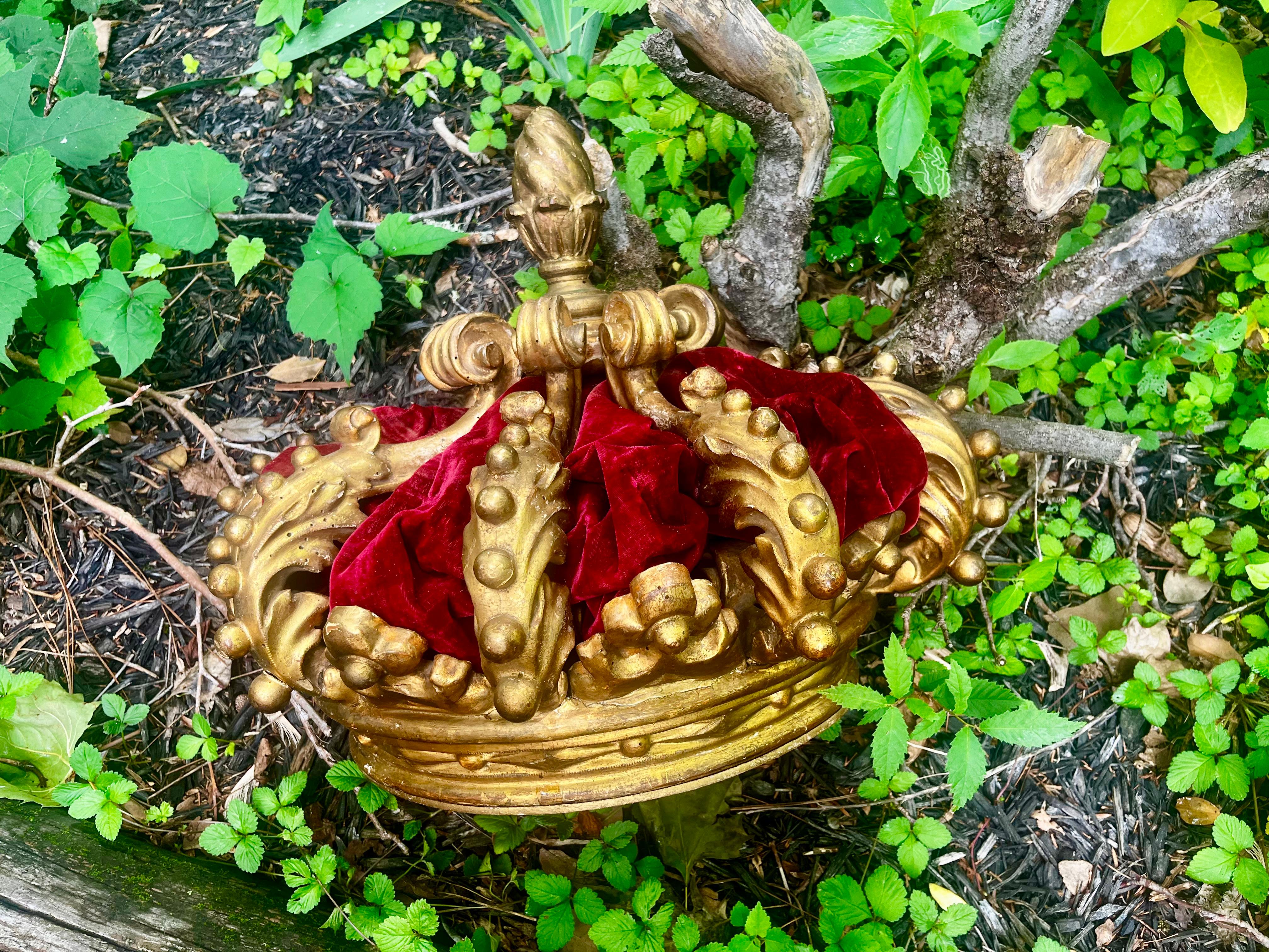 An antique carved and gilded wood  canopy of crown (corona) form . Nice old gold or gilt patina ,reflecting years of age probably in oil or coal heated boudoirs. Original purpose was to preside over a bed below with draperies flowing downwards. In