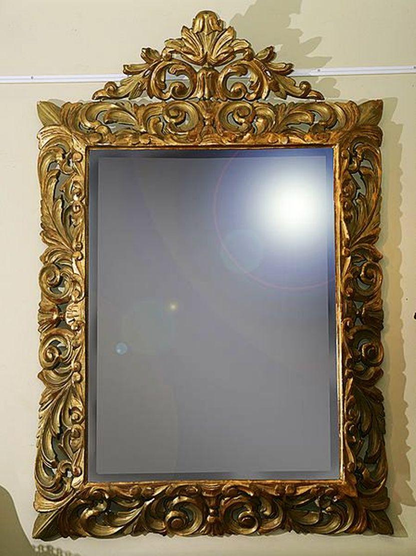 A William IV style giltwood mirror.
The crest and frame with acanthus carving, the mirror plate with a beveled edge.
Some spotting to the mirror plate to the corners.