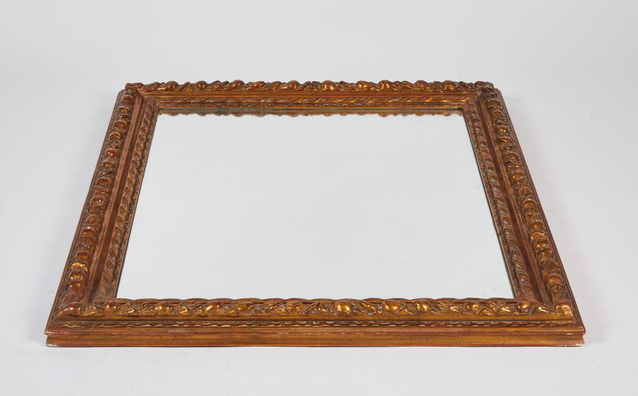 Nicely proportioned warm carved giltwood framed mirror. Perfect over a fireplace mantel or in a powder room. 



 