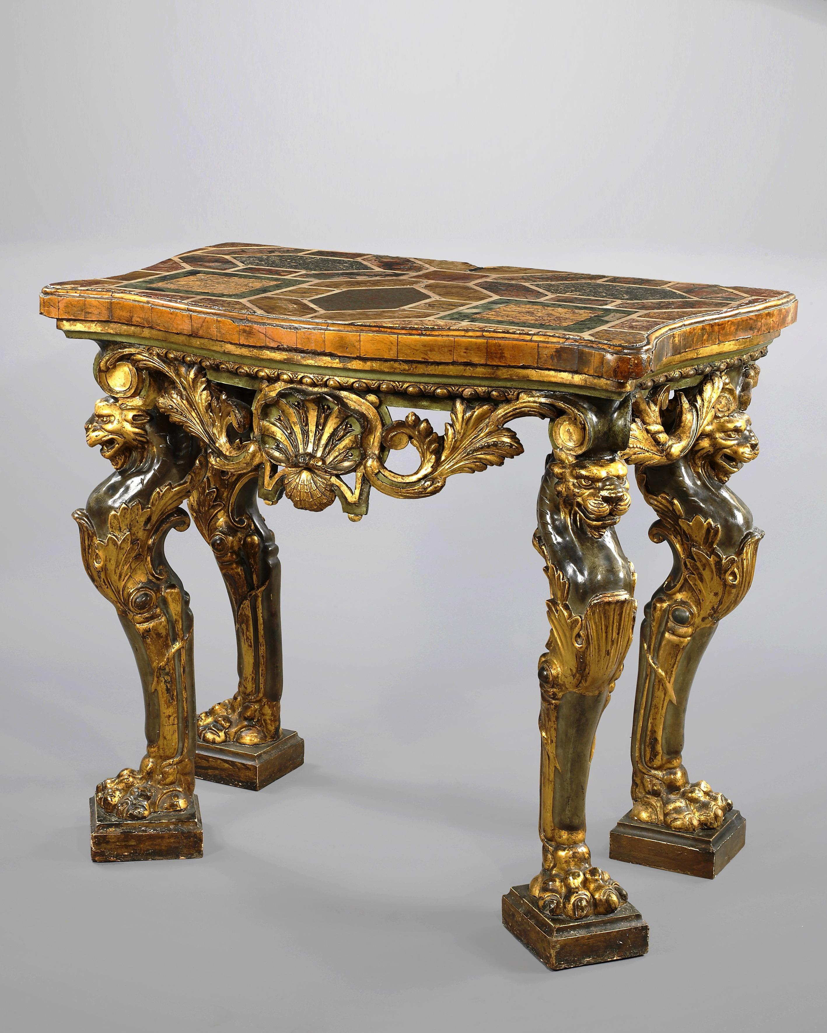 Exceptional carved giltwood Italian console table, with top made of inlays of various marbles, 19th century
The apron is decorated with foliated scrolls and seashells, lying on four legs representing sheathed lions.
The undulated marble top is