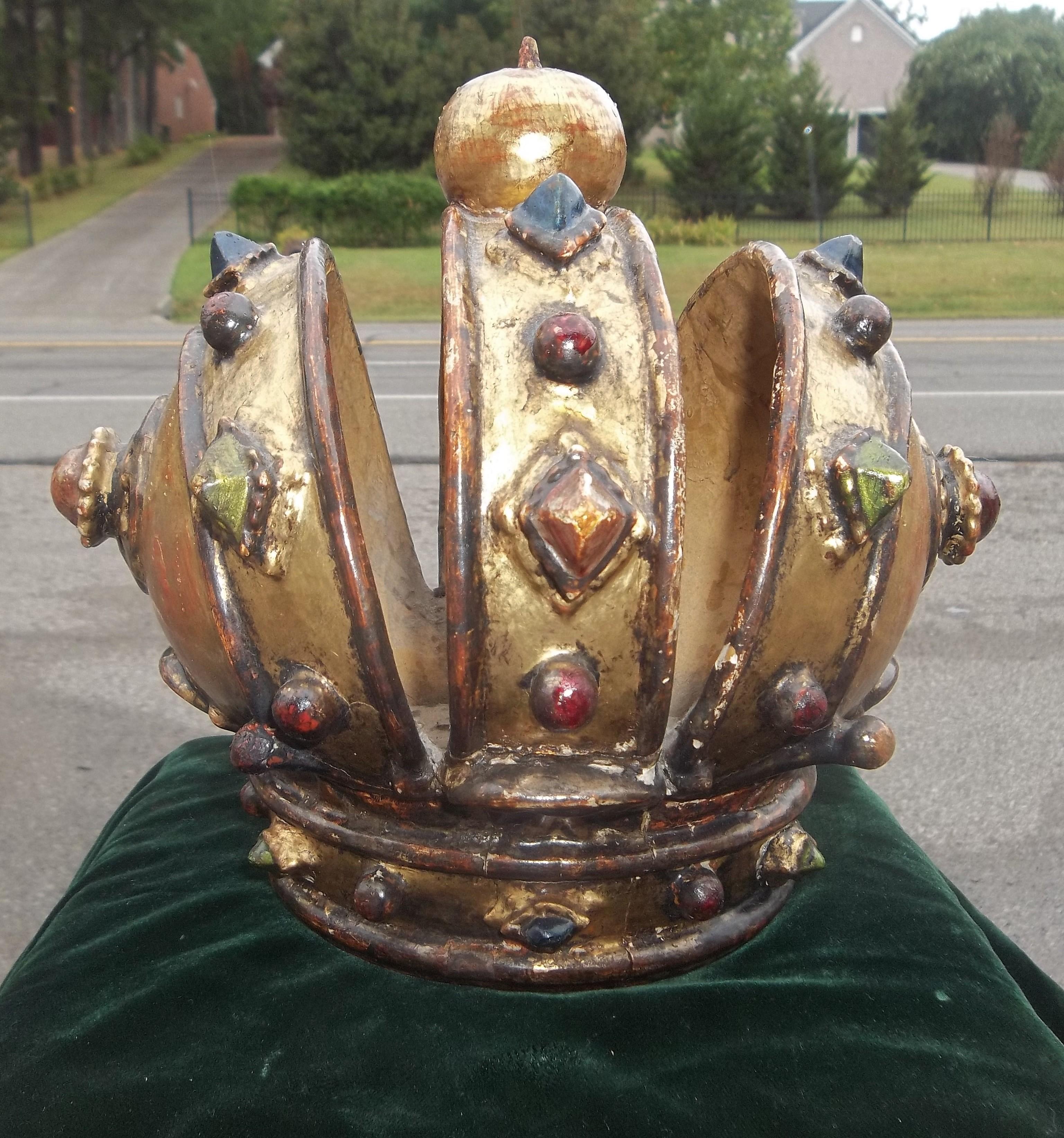 Highly decorative and difficult to find. Probably from a church altar setting, the crown from Mary or a prominent saint. Gilded with carved jewels colored to resemble jewels (emeralds, rubies, sapphires). 

Usual wear and losses to the gilding