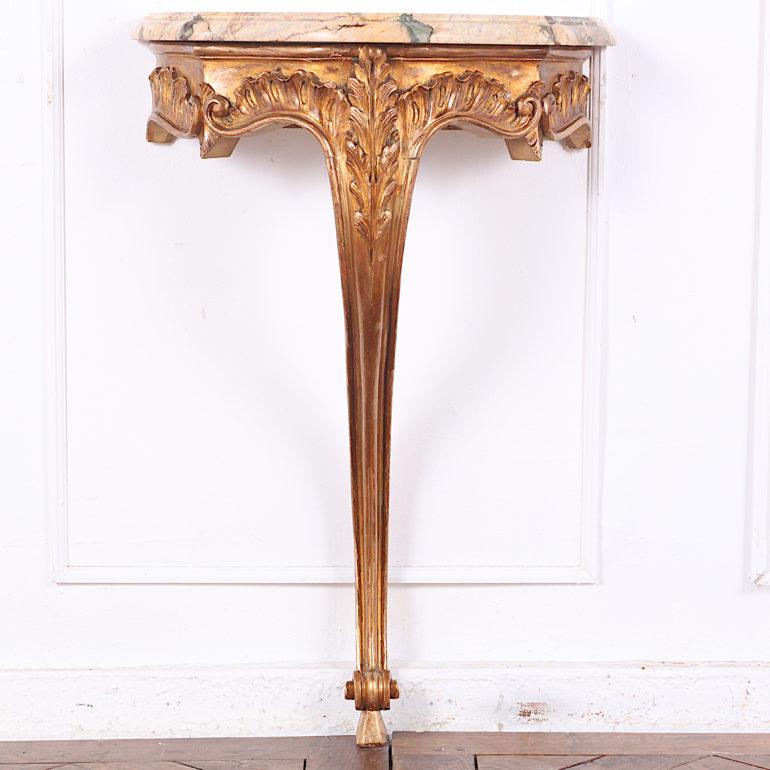 Lovely-quality French carved and gilt Louis XV style wall-mounted marble-top console table with foliate carved details and an elegant serpentine leg with scrolled foot.

     