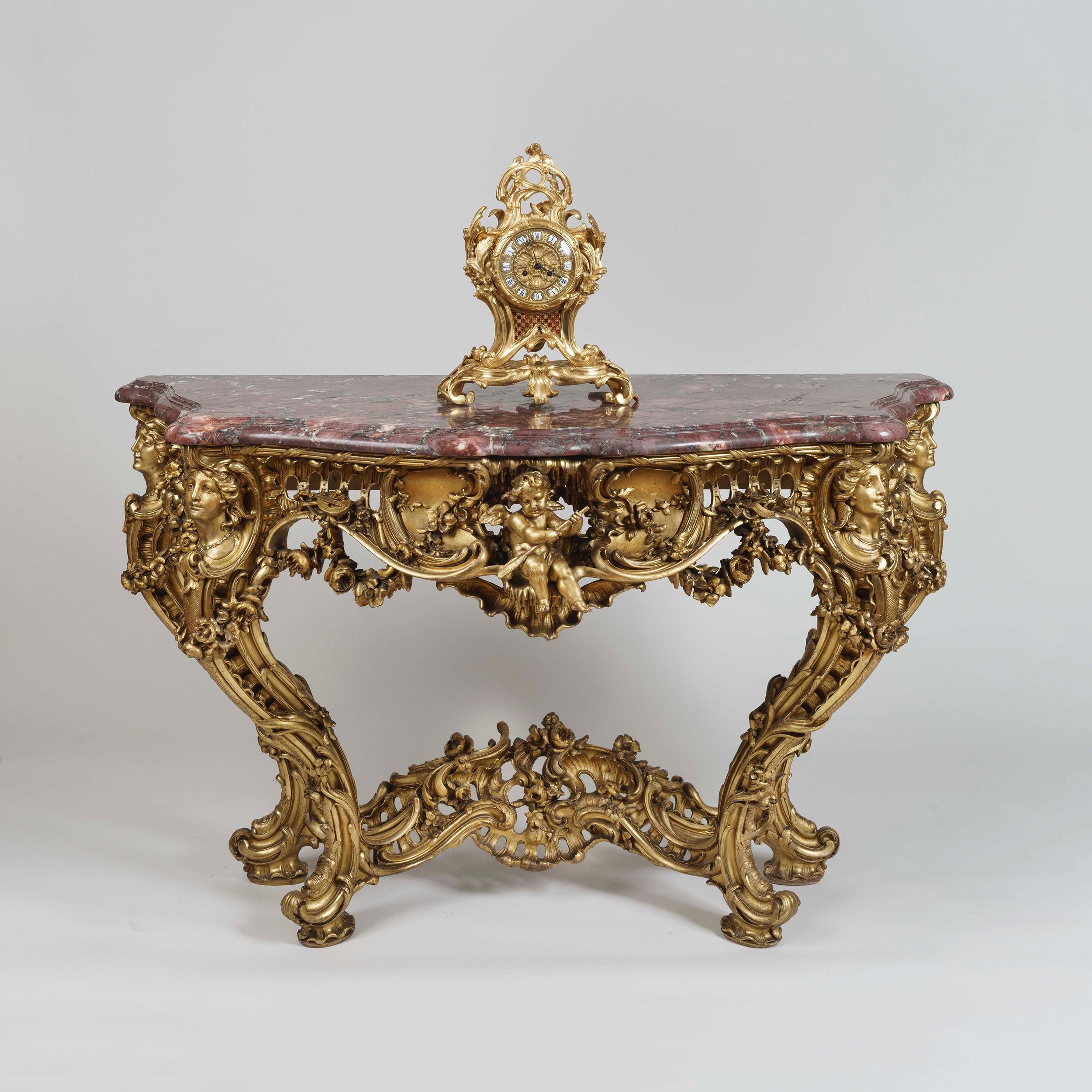 A Louis XV style console table
In the manner of Nicolas Pineau

Carved from solid wood, the console table displaying its original water gilding and highlighting the virtuosity of its carver; the table rising from a scrolling base joined by a