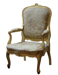 Carved giltwood Louis XVI style fauteille with original tapestry upholstery