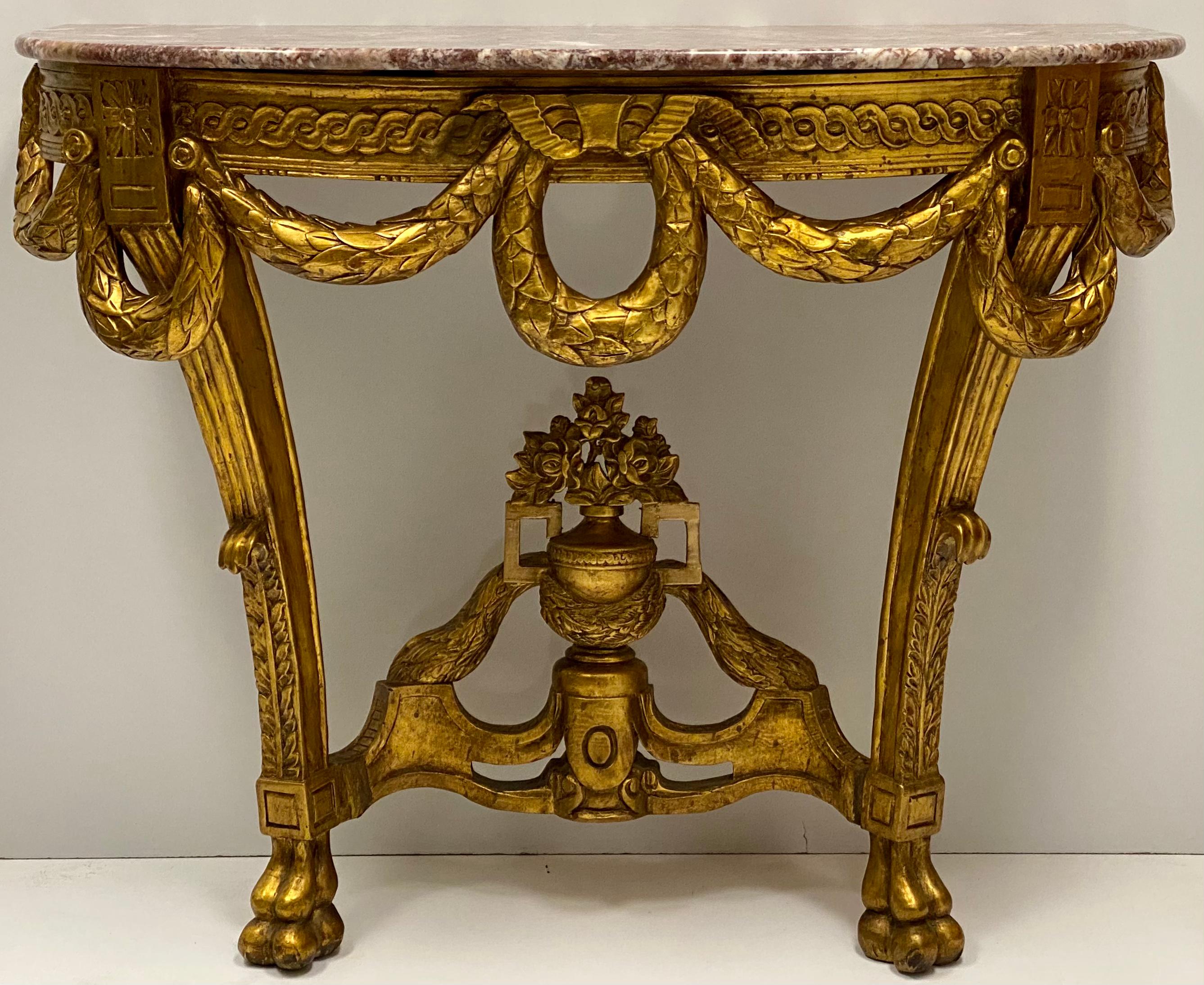 This is a wonderfully carved giltwood console table with rouge marble top. It mounts to the wall and the marble is not attached. It is from the later part of the 20th century.