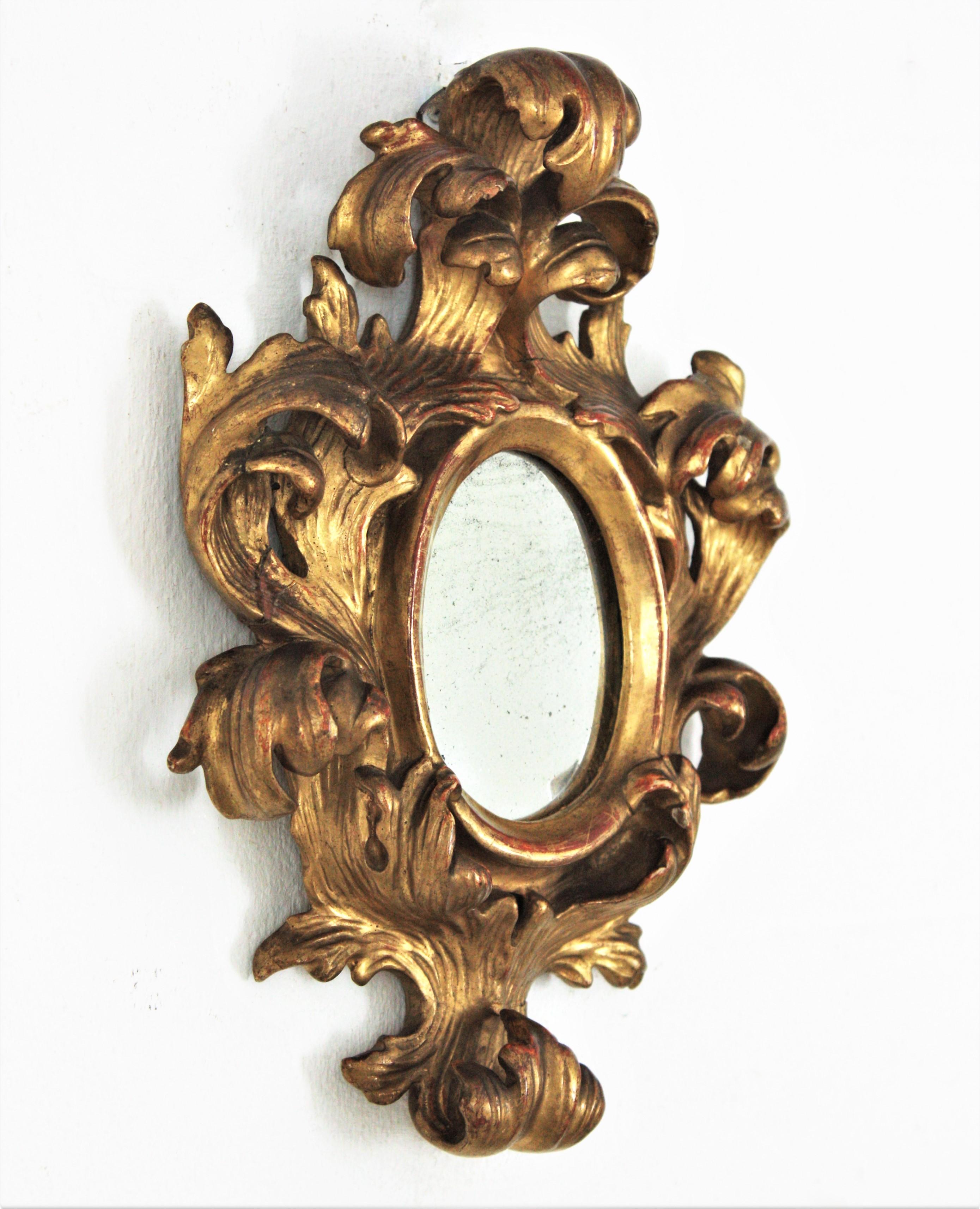 Hand-Crafted Spanish Rococo Carved Giltwood Mini Sized Mirror with Crest For Sale
