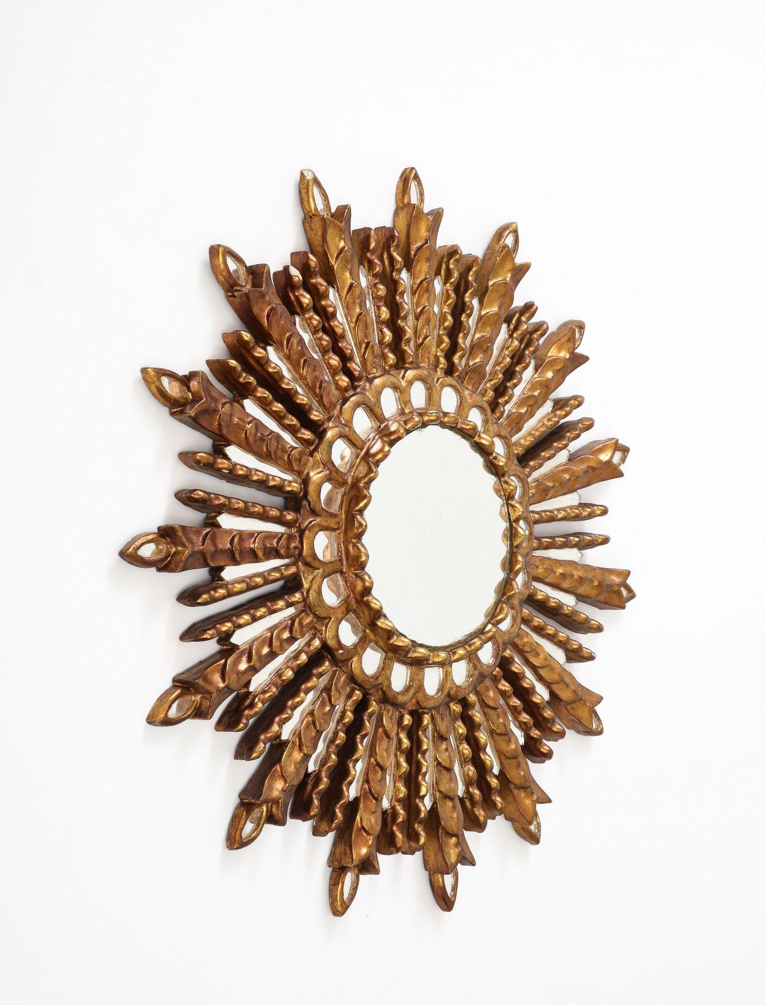 A giltwood and carved sunburst mirror C 1950 Measures: Diameter: 23