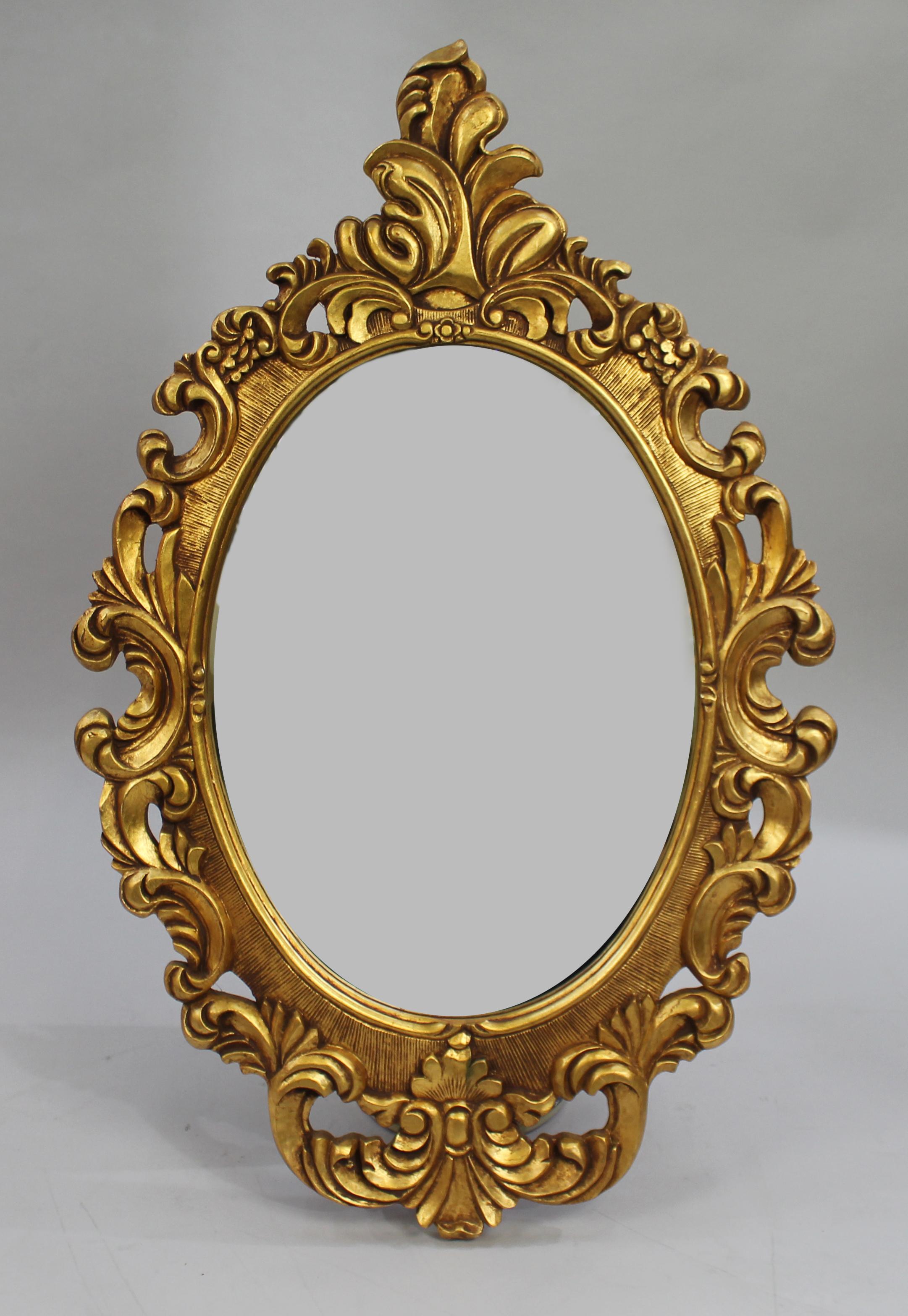 Carved giltwood wall mirror


Hand carved wooden frame with gold leaf finish.

Oval mirror plate.

French manner, 1980's.

Very good condition with little wear to gold leaf only. Ready to hang

Measures 60 x 94 cm.