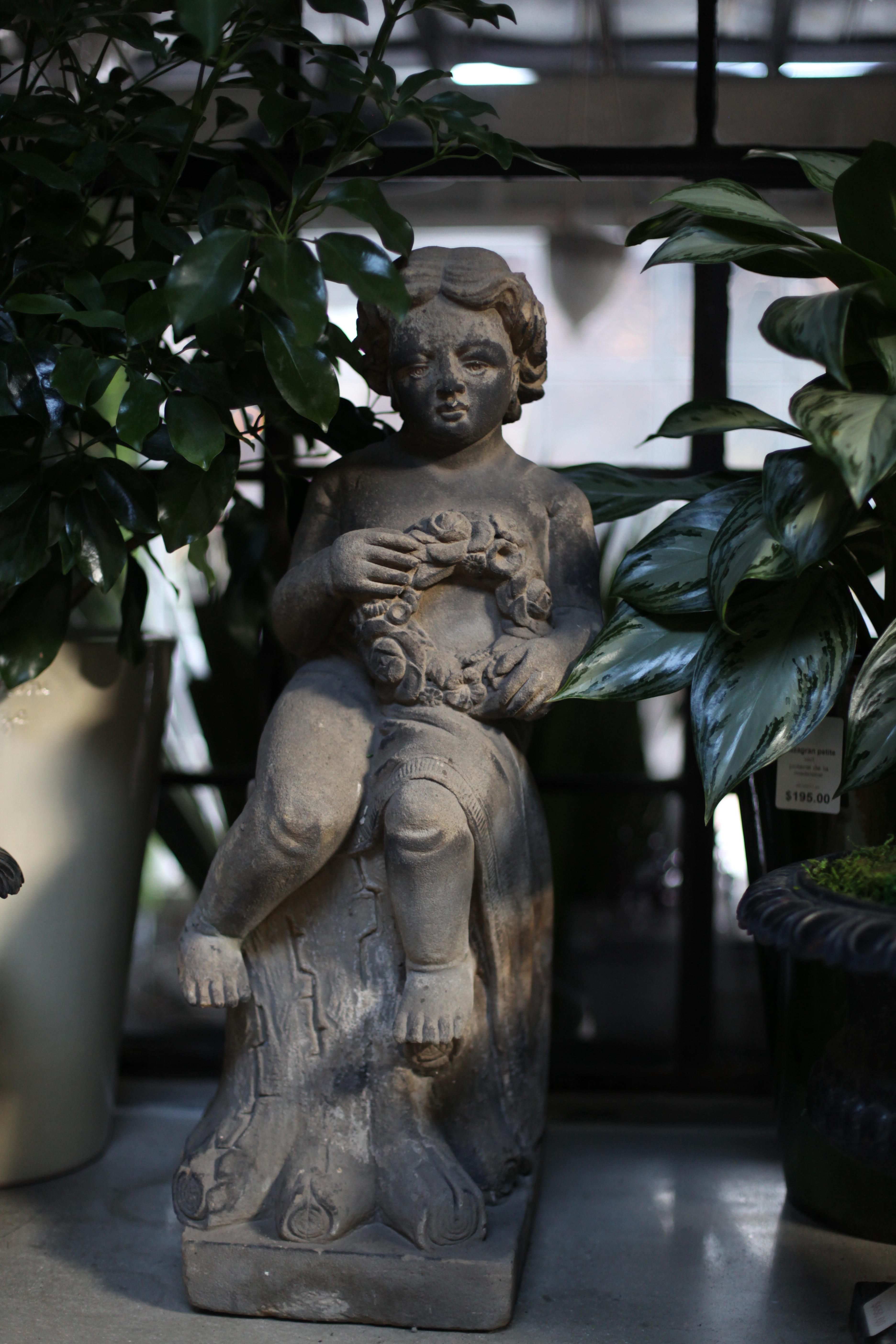 This Edwardian sculpture of a girl perched atop a faux bois stump will bring innocent charm to a terrace, conservatory, or garden. Carved from English sandstone, this sculpture is laced with alluring details, from the curl of her hair to the