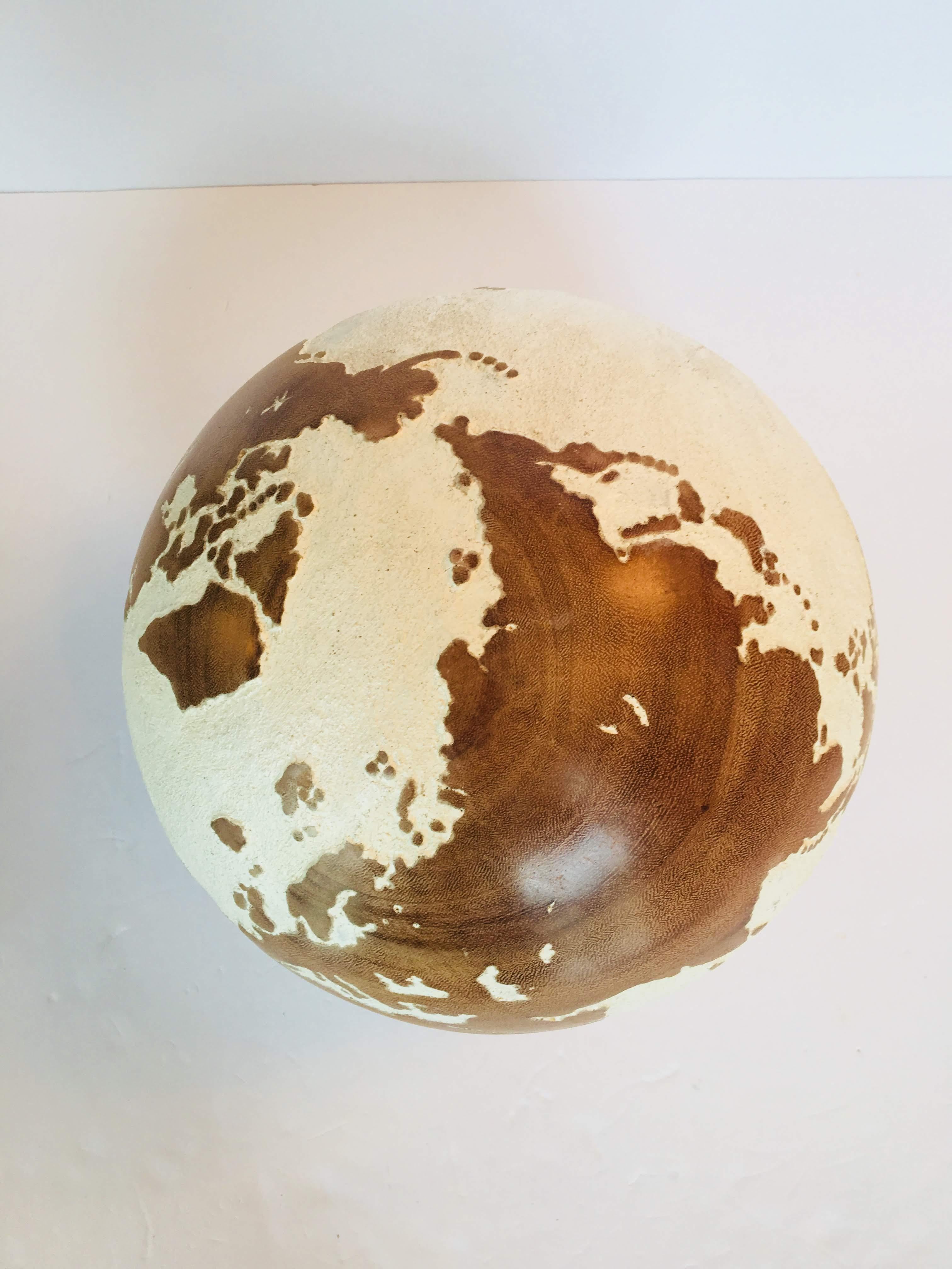 This 30 cm globe is from the 1st generation / made of Suar Wood / Acrylic resin
White painted solid wood carved globe on wooden stand. 
Made between 1998-2000
