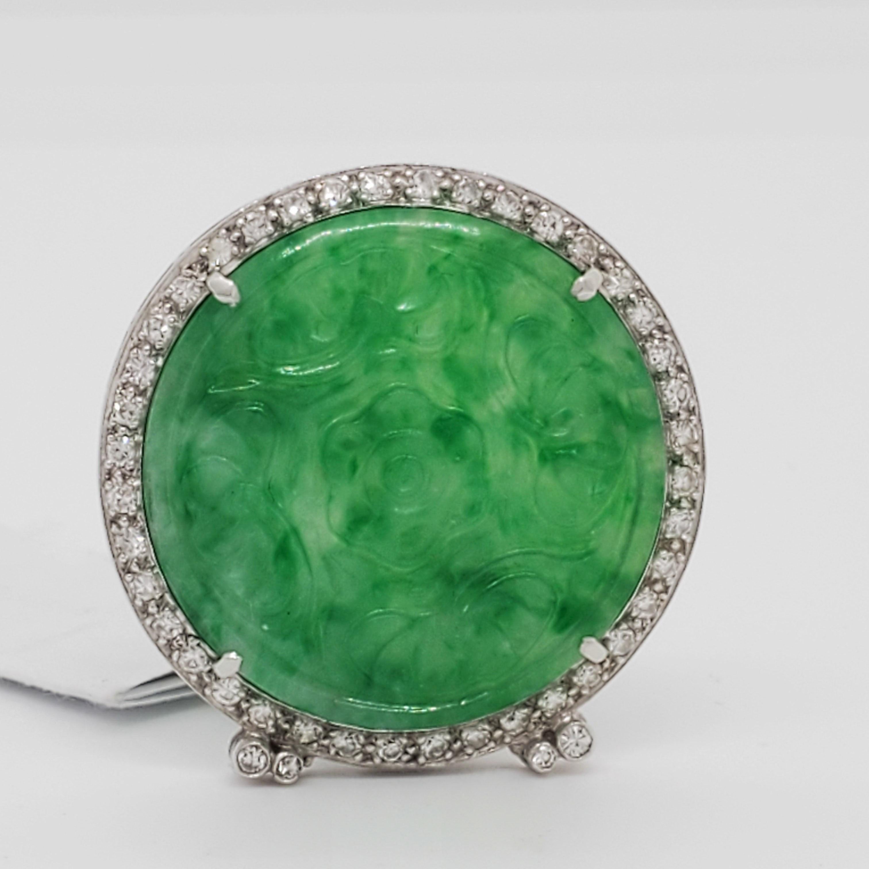 Gorgeous big carved green jade round with 0.10 ct. good quality white diamond rounds.  Handmade in platinum.