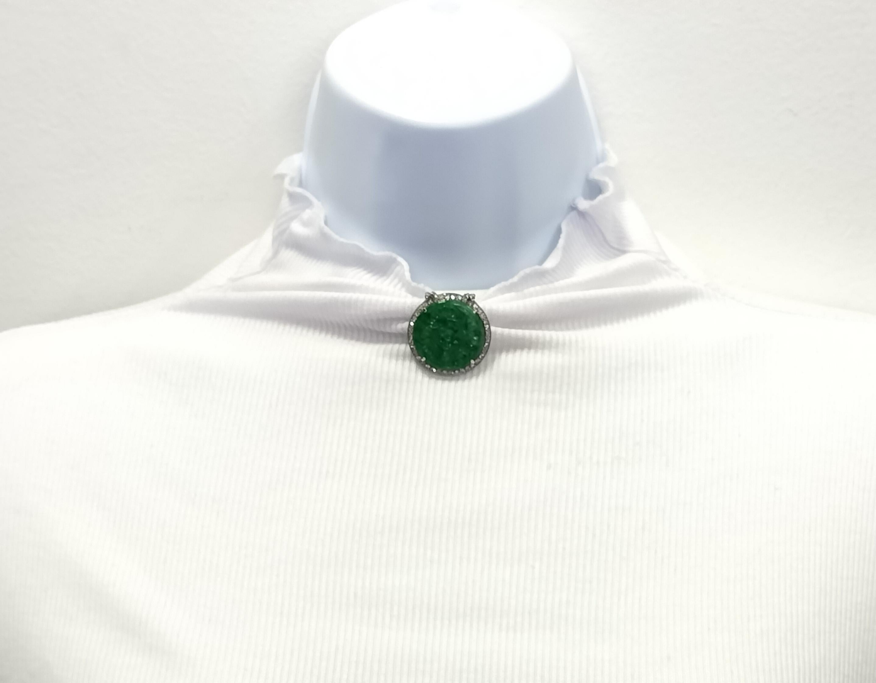 Beautiful big round carved green jade with 0.10 ct. white diamond rounds.  Handmade in platinum.  This brooch is symbolic of good luck and the jade is a nice bright green.