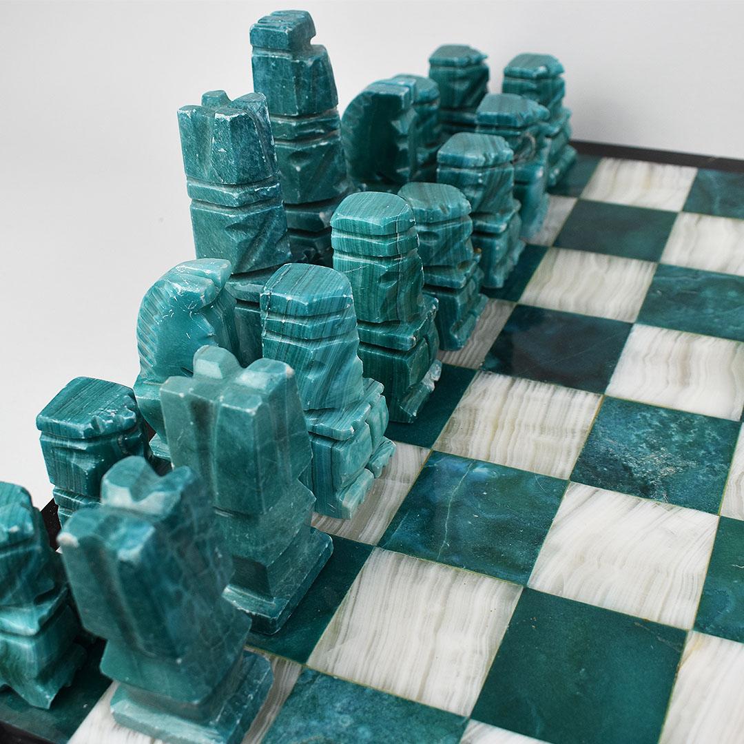 Complete green Malachite and white marble stone chessboard with game pieces. Hand carved from three different types of stone, this striking gameboard will be a gorgeous addition to any space. Game pieces are created in both green malachite on one