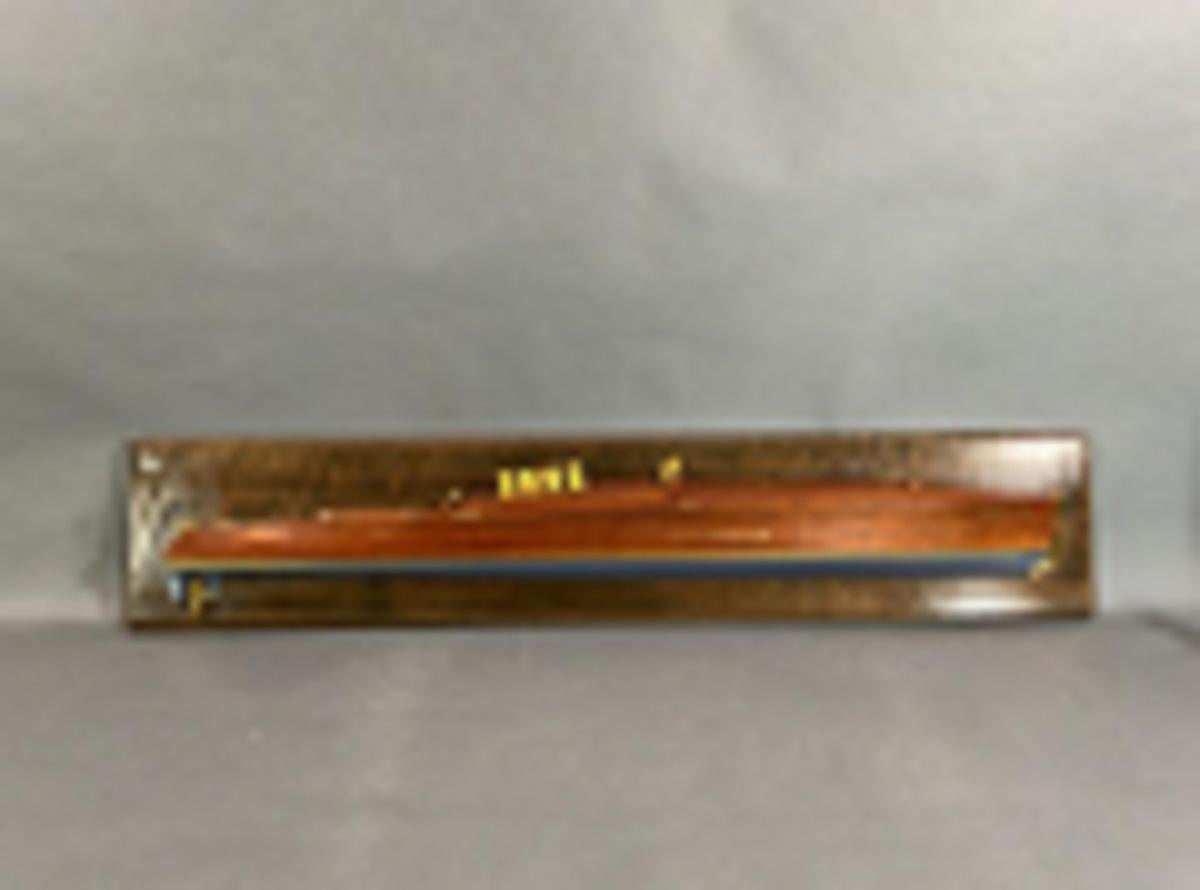 Half model of the gold cup racing speedboat Dixie II. Planked in mahogany with brass pins. Printed below the waterline with gold stripe. Deck has exhaust cowls, cleats, vent, etc. Mounted to a backboard.

Overall Dimensions: 10