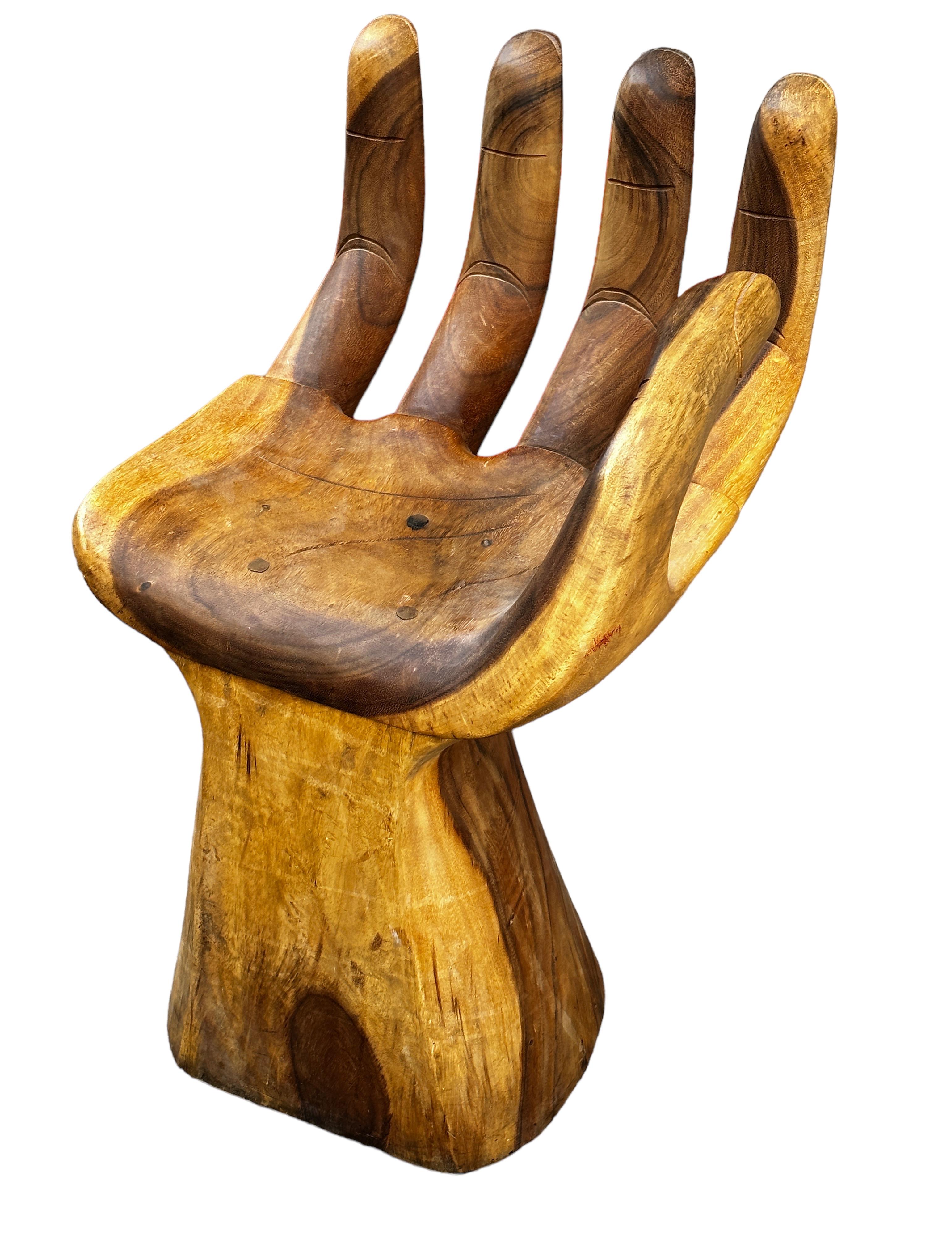 An amazing Mid-Century Modern finely detailed studio carved hand chair, circa 1970s, in the Style of Pedro Friedeberg, that brings both a meditative element and a unique functional sculpture into your home with the artisan crafted wood Carved Hand