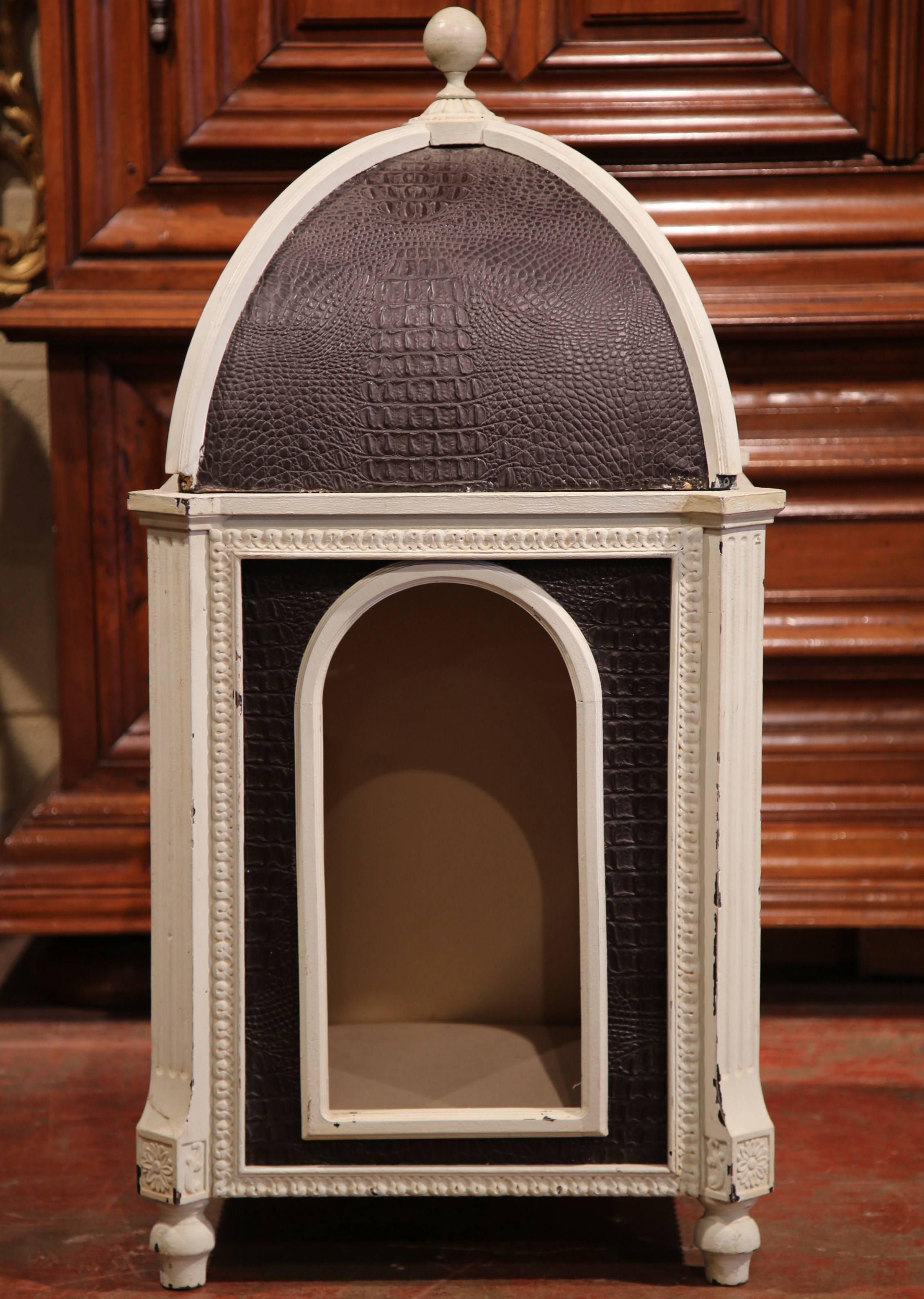 Treat your dog to something special with this Classic, one of a kind dog house from France. The carved frame dog bed with dome top stands on four small feet, it is hand painted white and upholstered with brown leather that imitates crocodile hide.