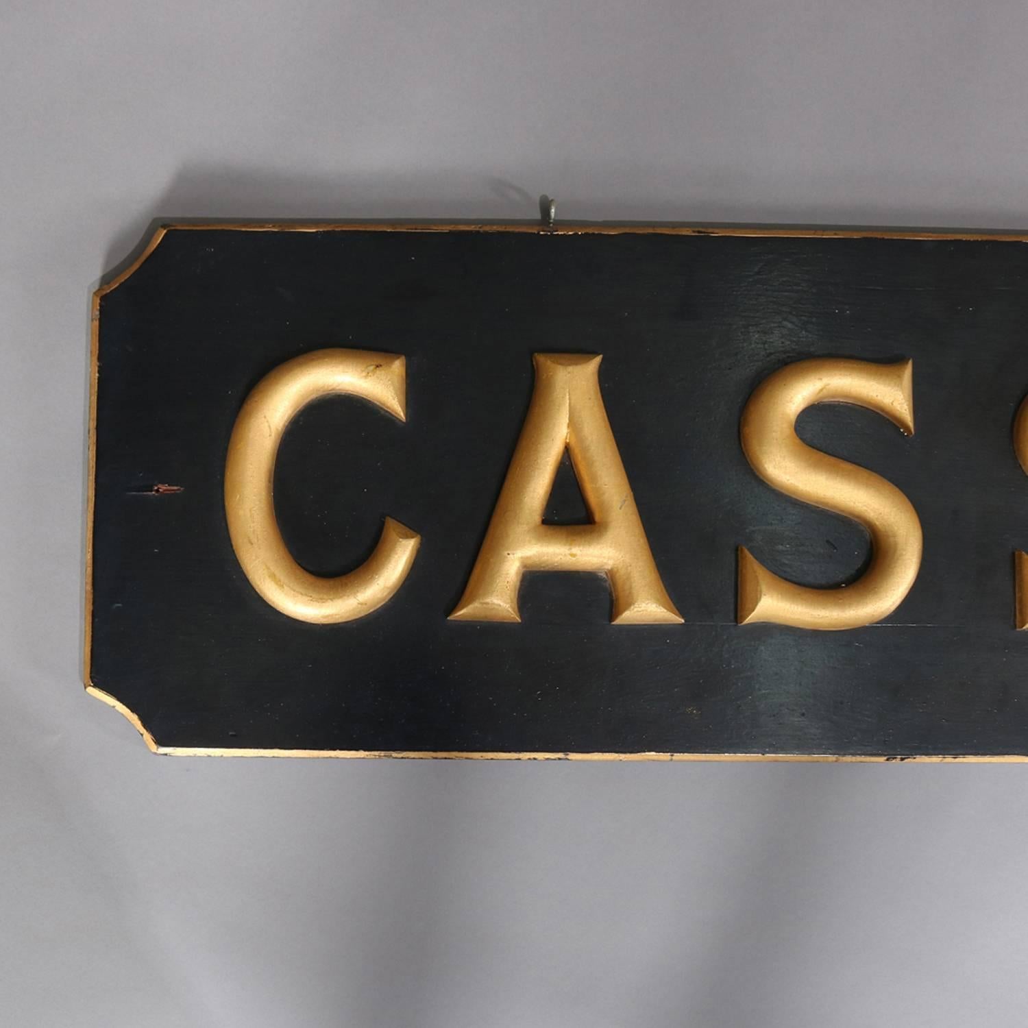 Carved wood advertising sign features high relief 