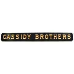 Carved High Relief Painted and Gilt "Cassidy Brothers" Wood Advertising Sign